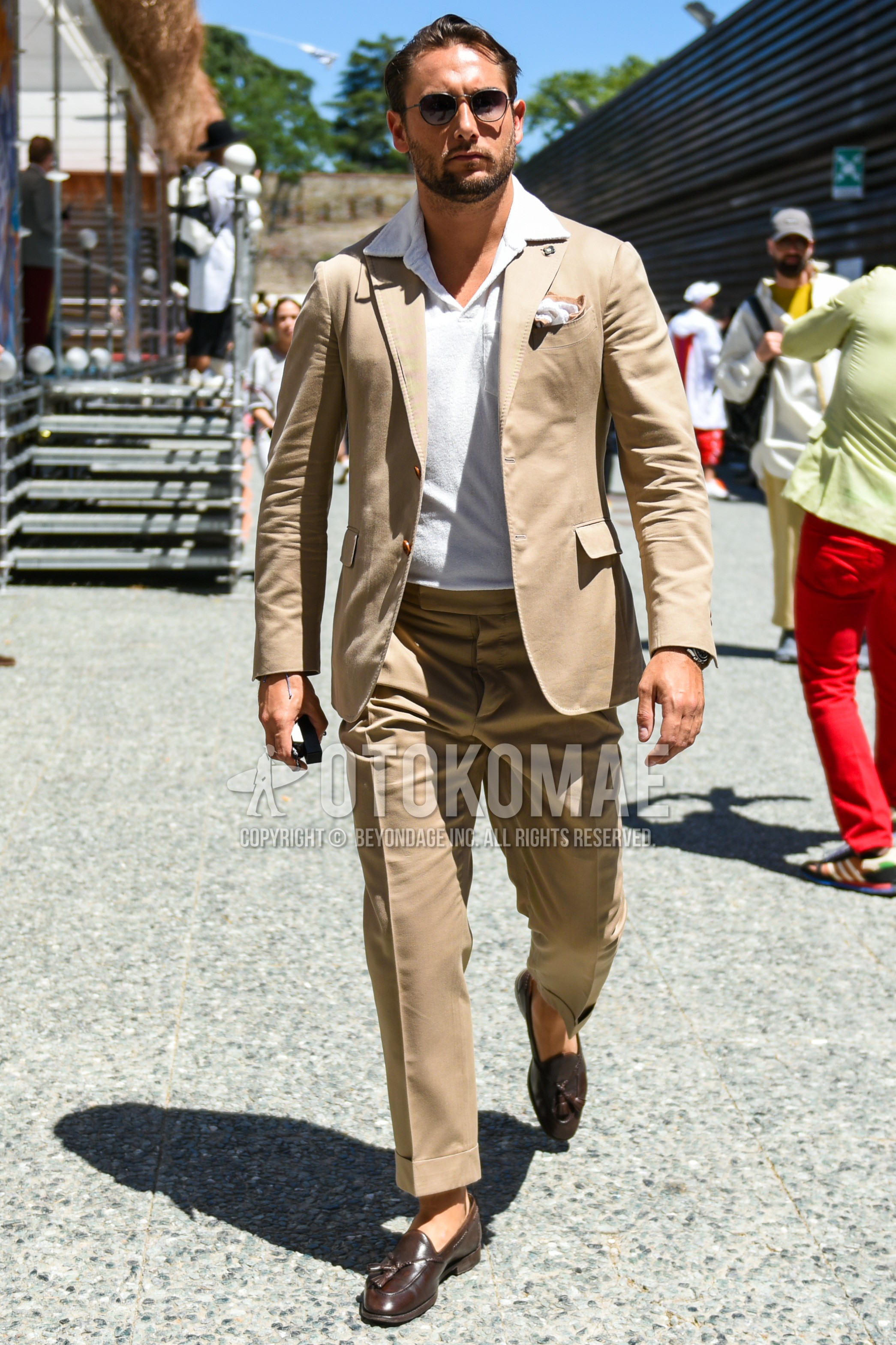 Men's spring summer autumn outfit with silver plain sunglasses, white plain polo shirt, brown tassel loafers leather shoes, beige plain suit.