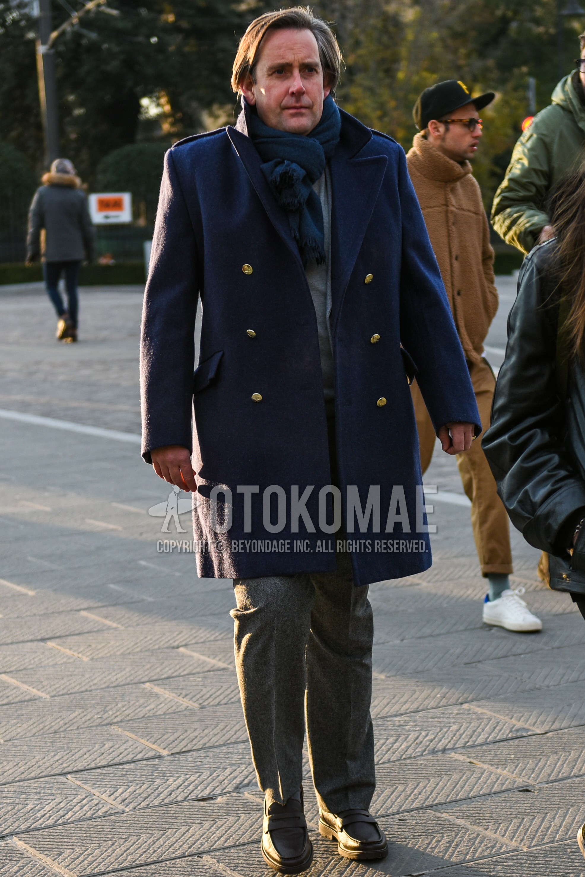 Men's autumn winter outfit with navy plain scarf, navy plain chester coat, gray plain slacks, black coin loafers leather shoes.