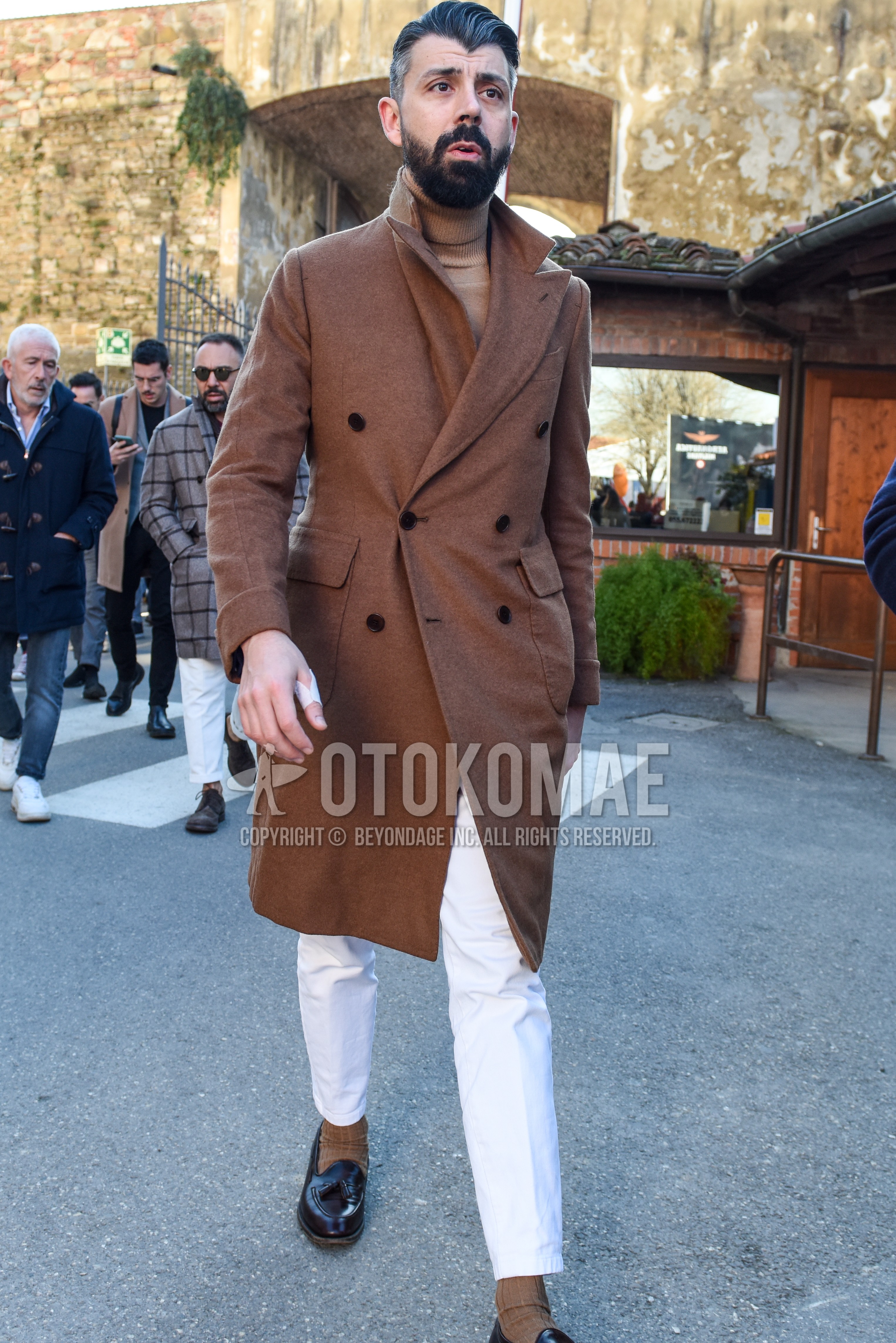Men's autumn winter outfit with brown plain chester coat, beige plain turtleneck knit, white plain cotton pants, white plain ankle pants, beige plain socks, brown tassel loafers leather shoes.