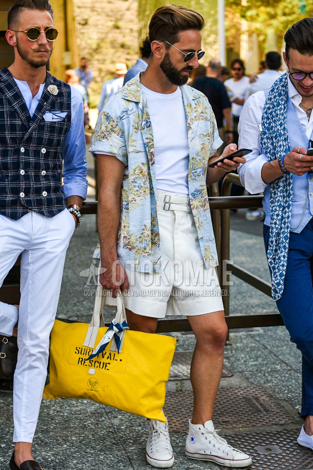 Men's summer outfit with black gold plain sunglasses, light blue tops/innerwear shirt, white plain t-shirt, white plain short pants, white high-cut sneakers, yellow graphic briefcase/handbag.