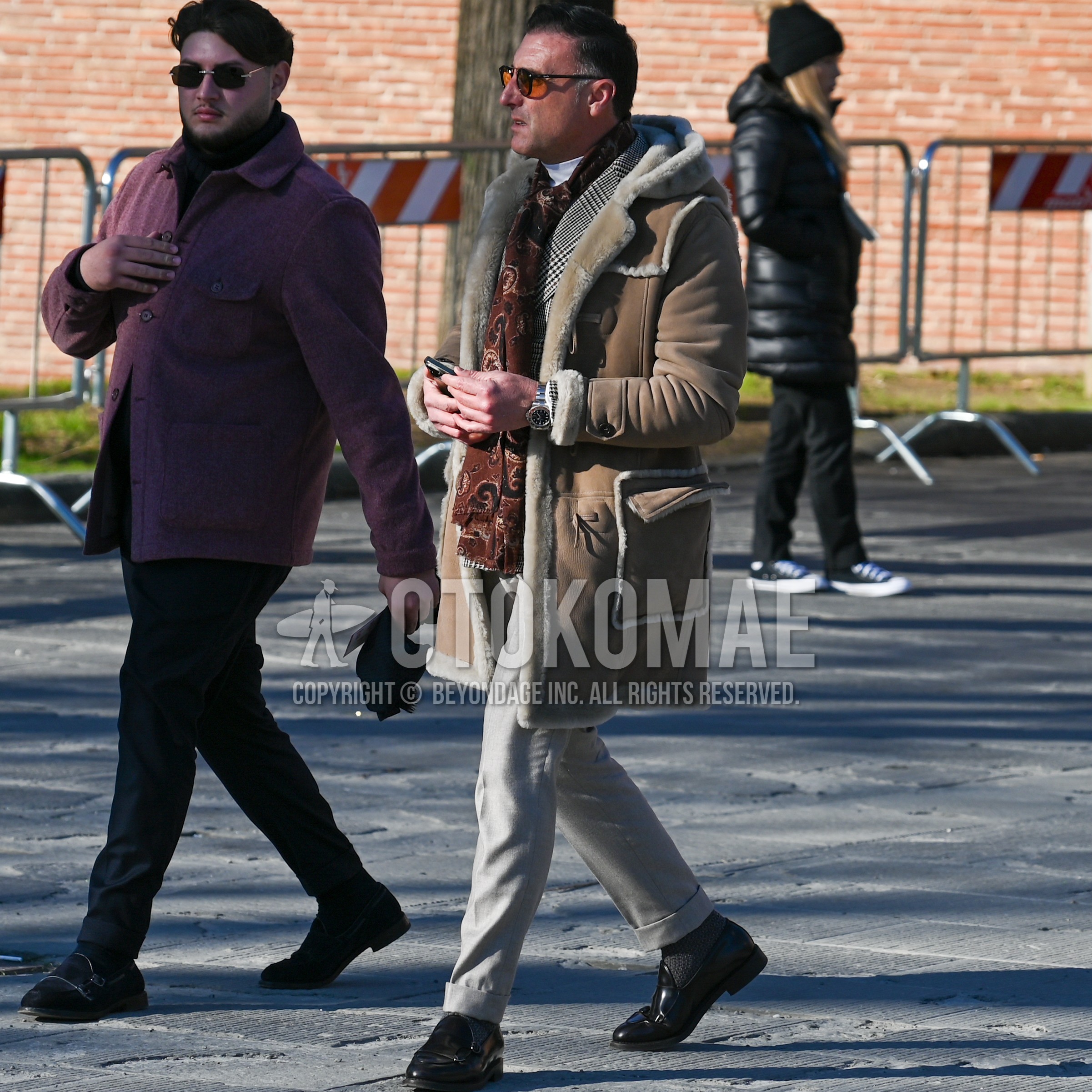 Men's winter outfit with black plain sunglasses, red plain scarf, beige plain boa jacket / coat, gray check tailored jacket, white plain turtleneck knit, beige plain slacks, gray plain socks, black tassel loafers leather shoes.