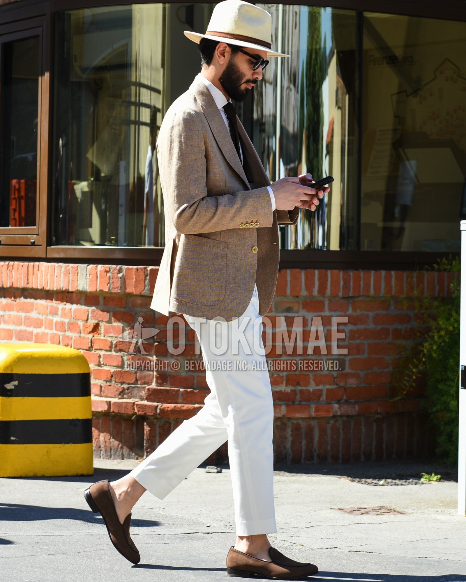 Men's spring summer outfit with beige plain hat, brown tortoiseshell sunglasses, beige plain tailored jacket, white plain shirt, white plain slacks, brown  loafers leather shoes, black plain knit tie.