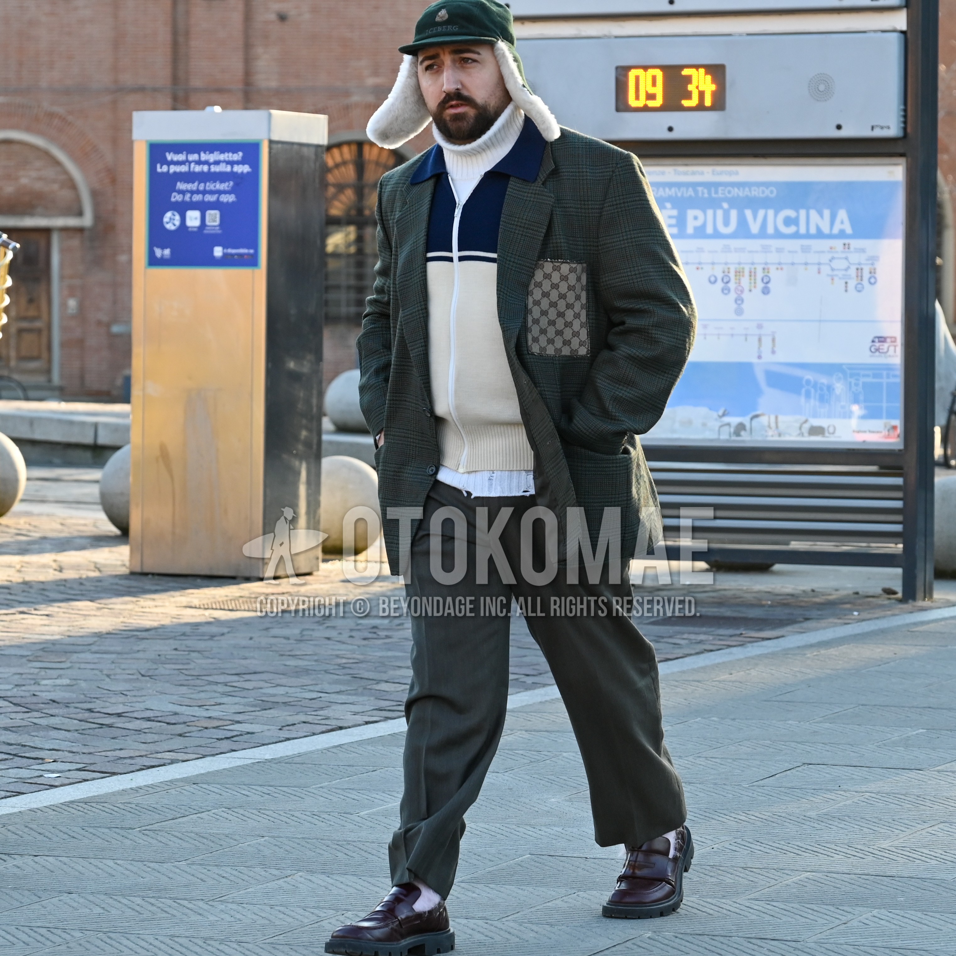 Men's autumn winter outfit with olive green one point jet cap, dark gray check tailored jacket, navy white tops/innerwear cardigan, white plain turtleneck knit, dark gray plain slacks, white plain socks, brown coin loafers leather shoes.