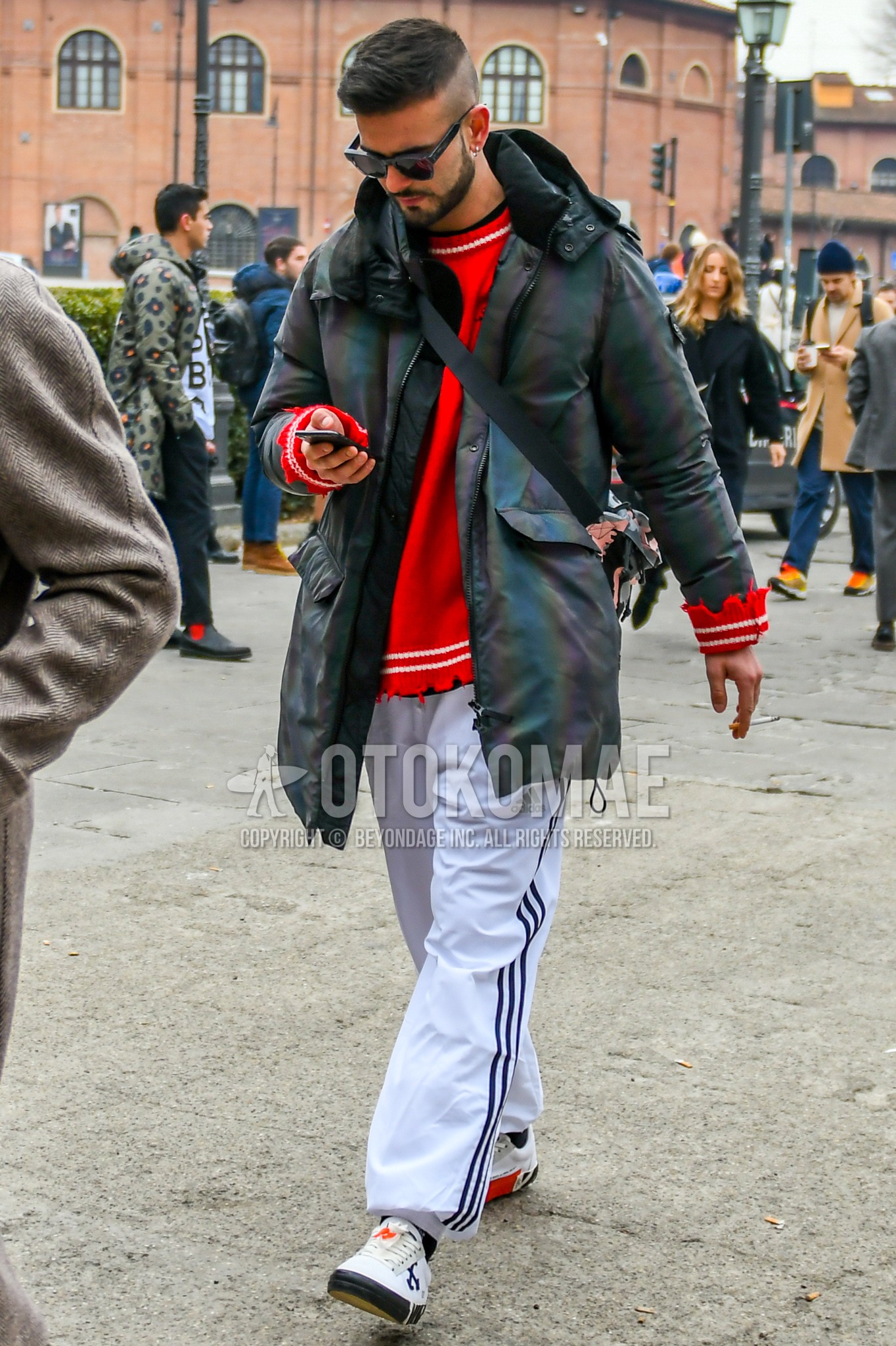 Men's winter outfit with black plain sunglasses, gray plain hooded coat, red plain sweater, white plain sideline pants, white low-cut sneakers.