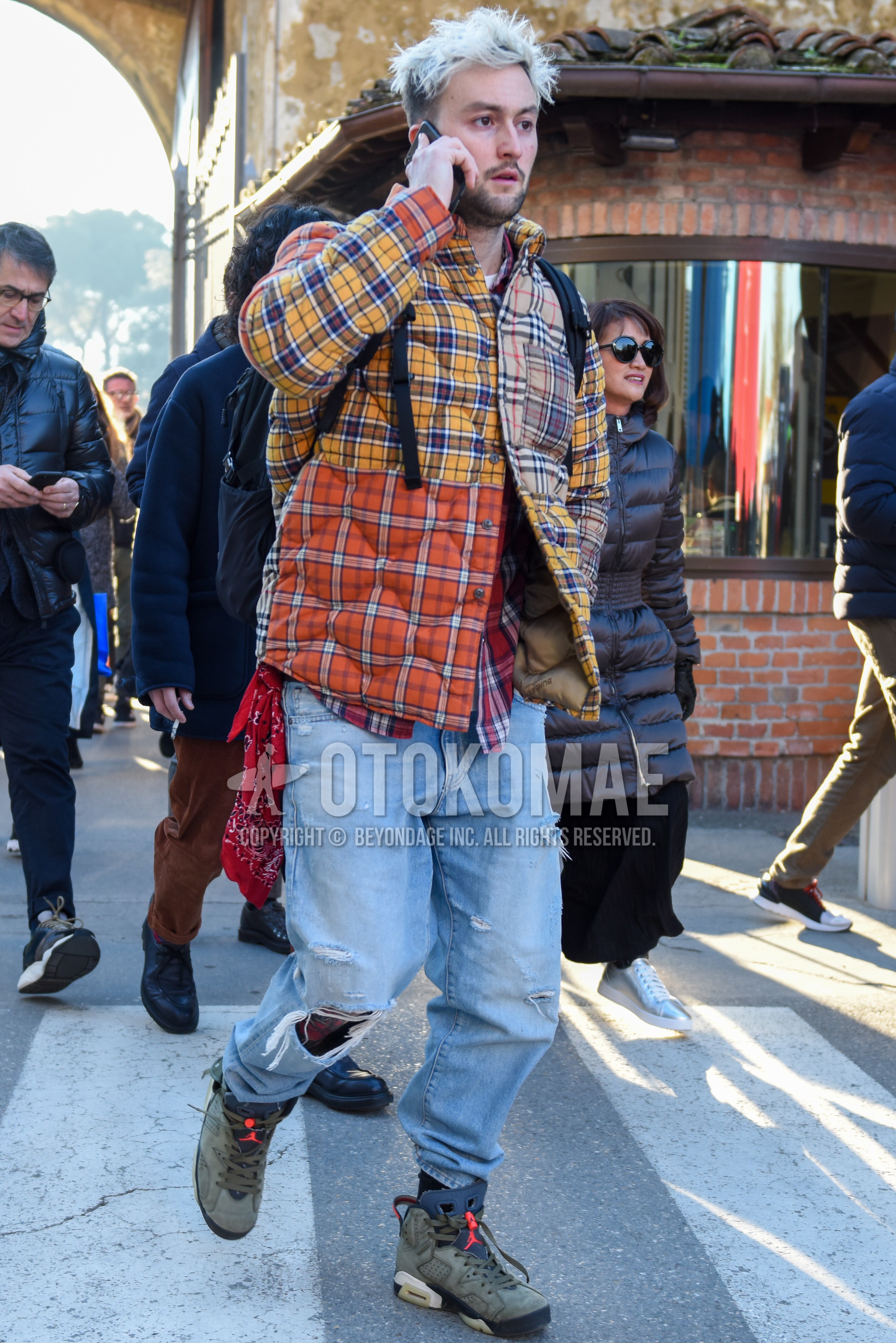 Men's autumn winter outfit with multi-color check shirt jacket, multi-color check down jacket, red check shirt, blue plain damaged jeans, olive green high-cut sneakers.