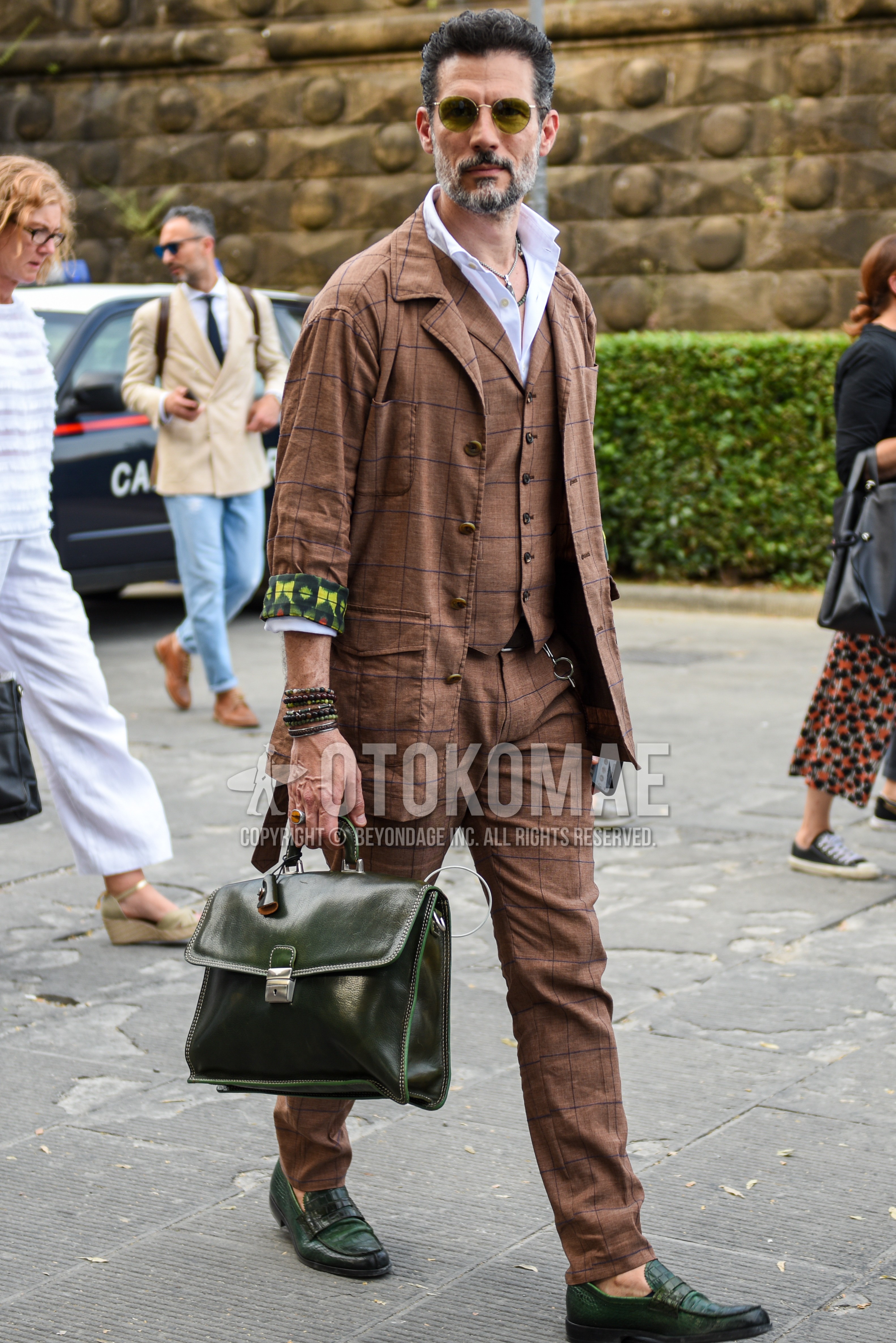 Men's spring summer autumn outfit with yellow plain sunglasses, white plain shirt, olive green coin loafers leather shoes, olive green plain briefcase/handbag, brown check three-piece suit.