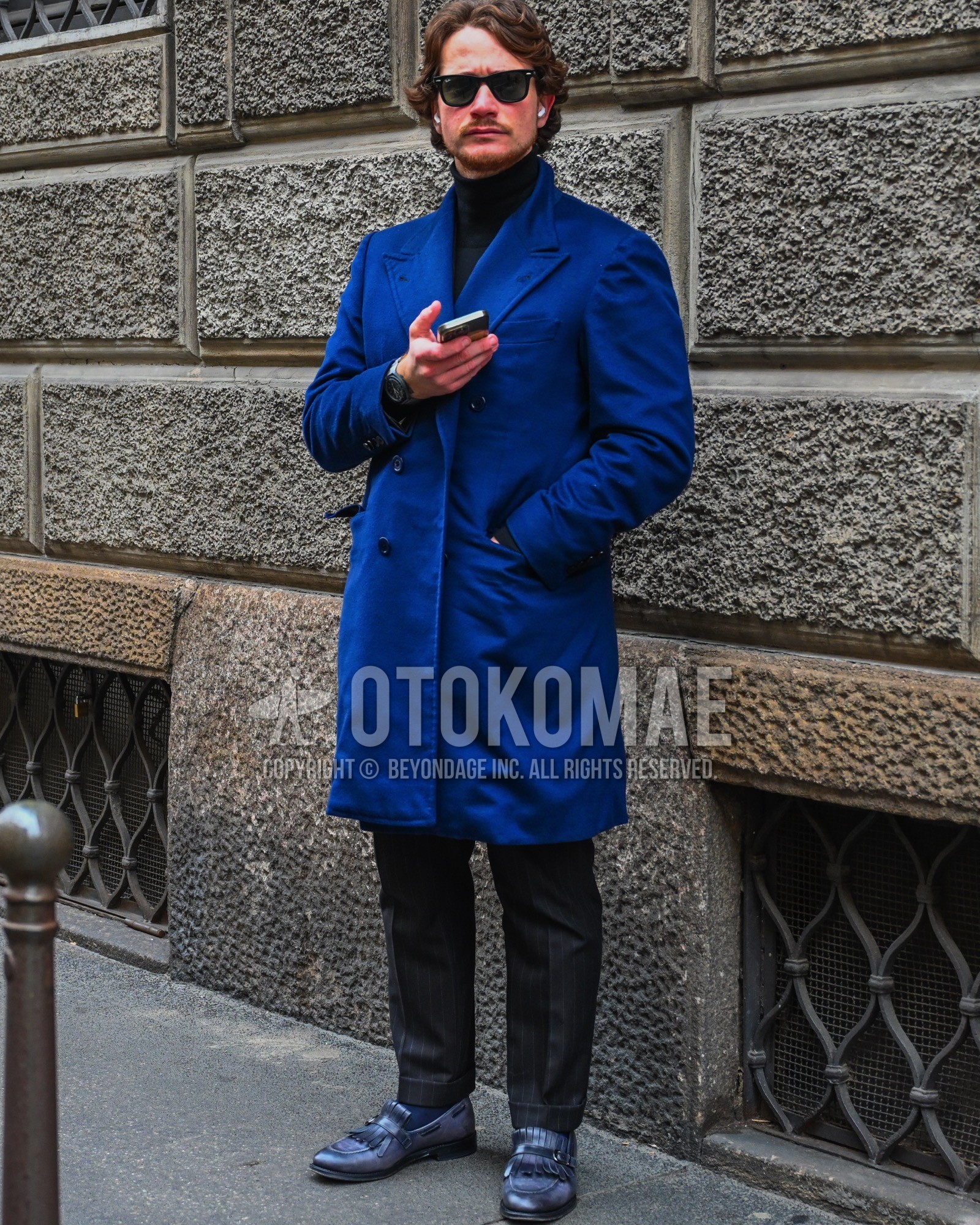 Men's autumn winter outfit with black plain sunglasses, blue plain chester coat, black plain turtleneck knit, dark gray stripes slacks, navy plain socks, navy  loafers leather shoes.