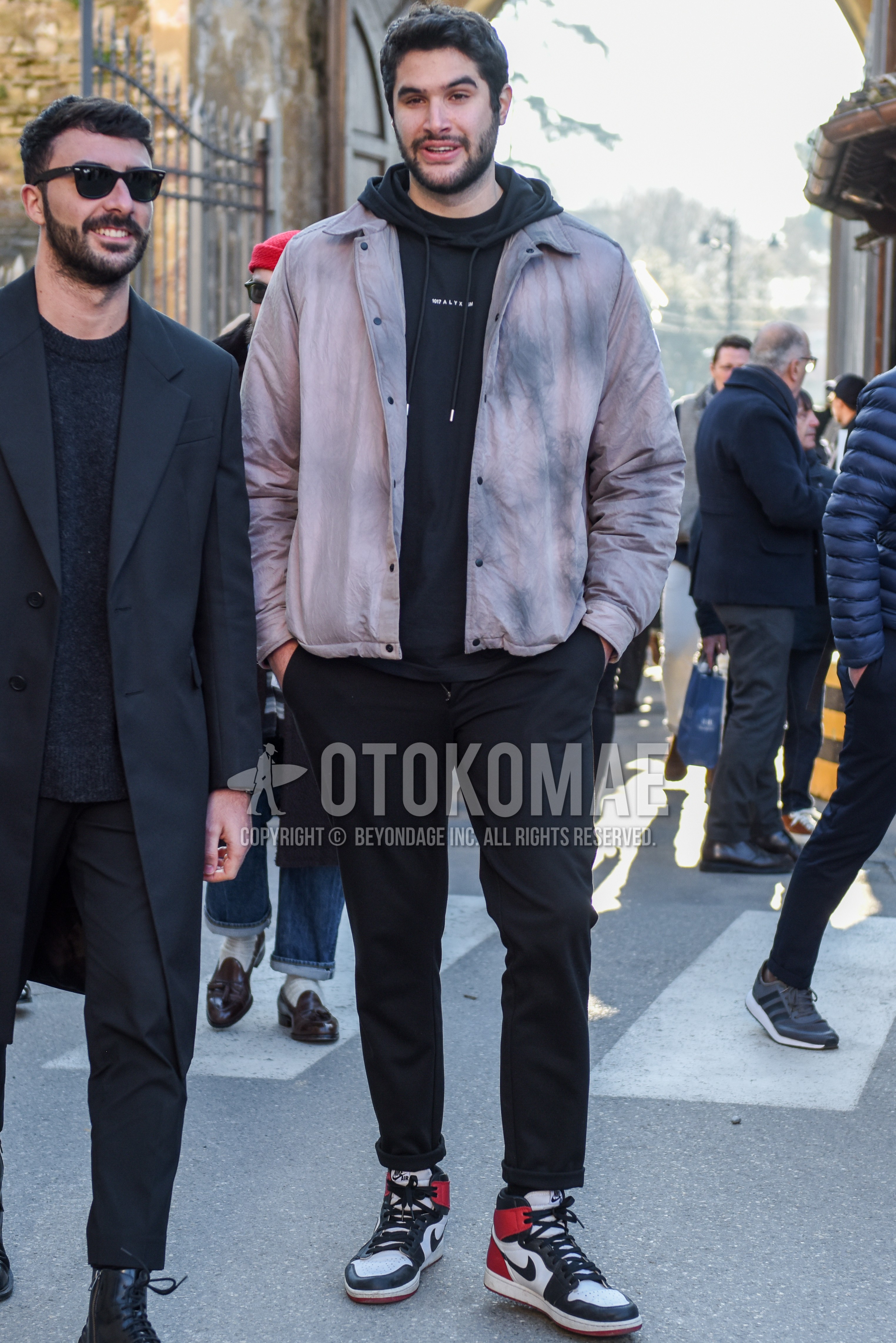 Men's spring autumn outfit with gray outerwear coach jacket, black one point hoodie, black plain slacks, black plain socks, white black red high-cut sneakers.