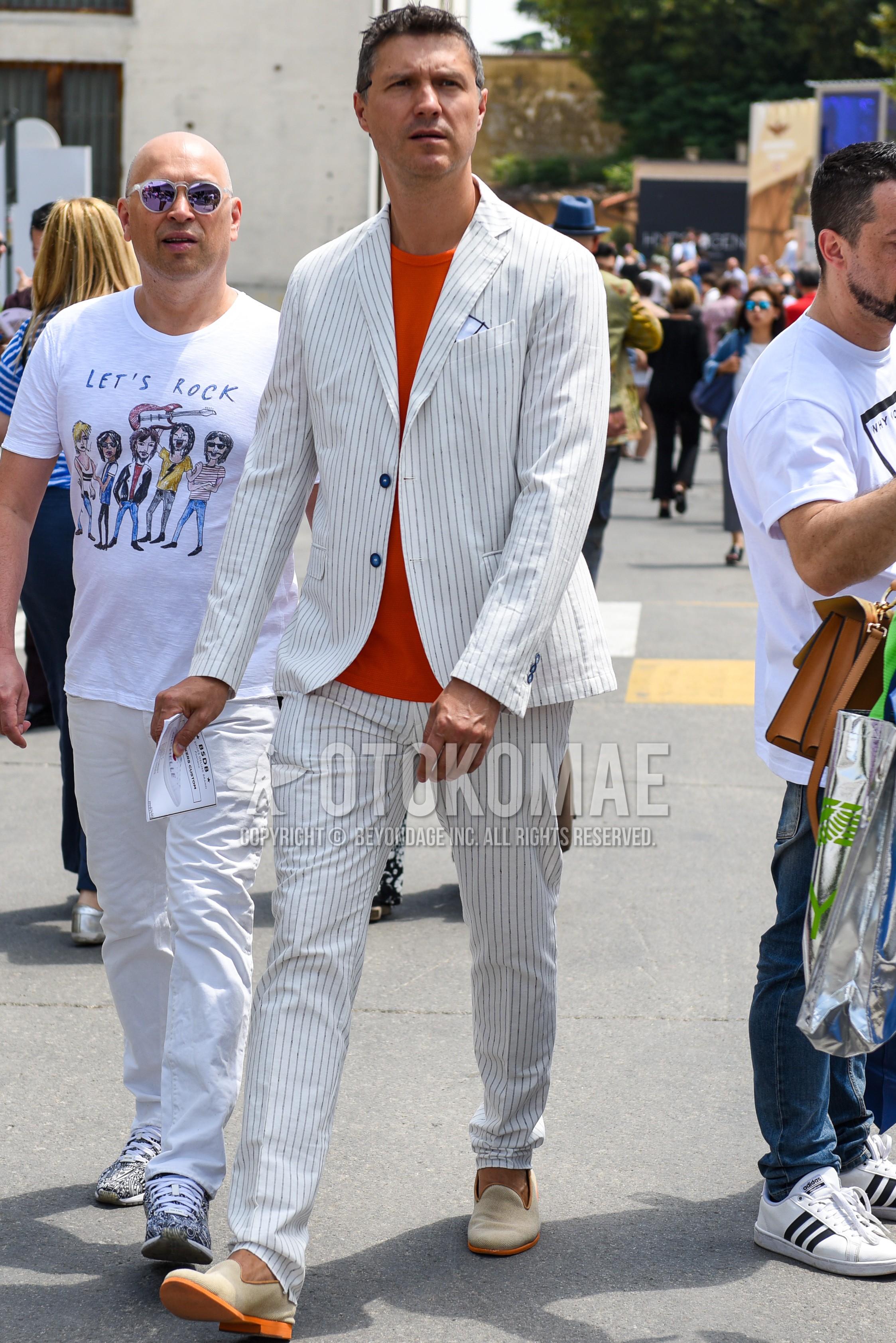 Men's spring summer autumn outfit with orange plain t-shirt, beige  loafers leather shoes, white stripes suit.