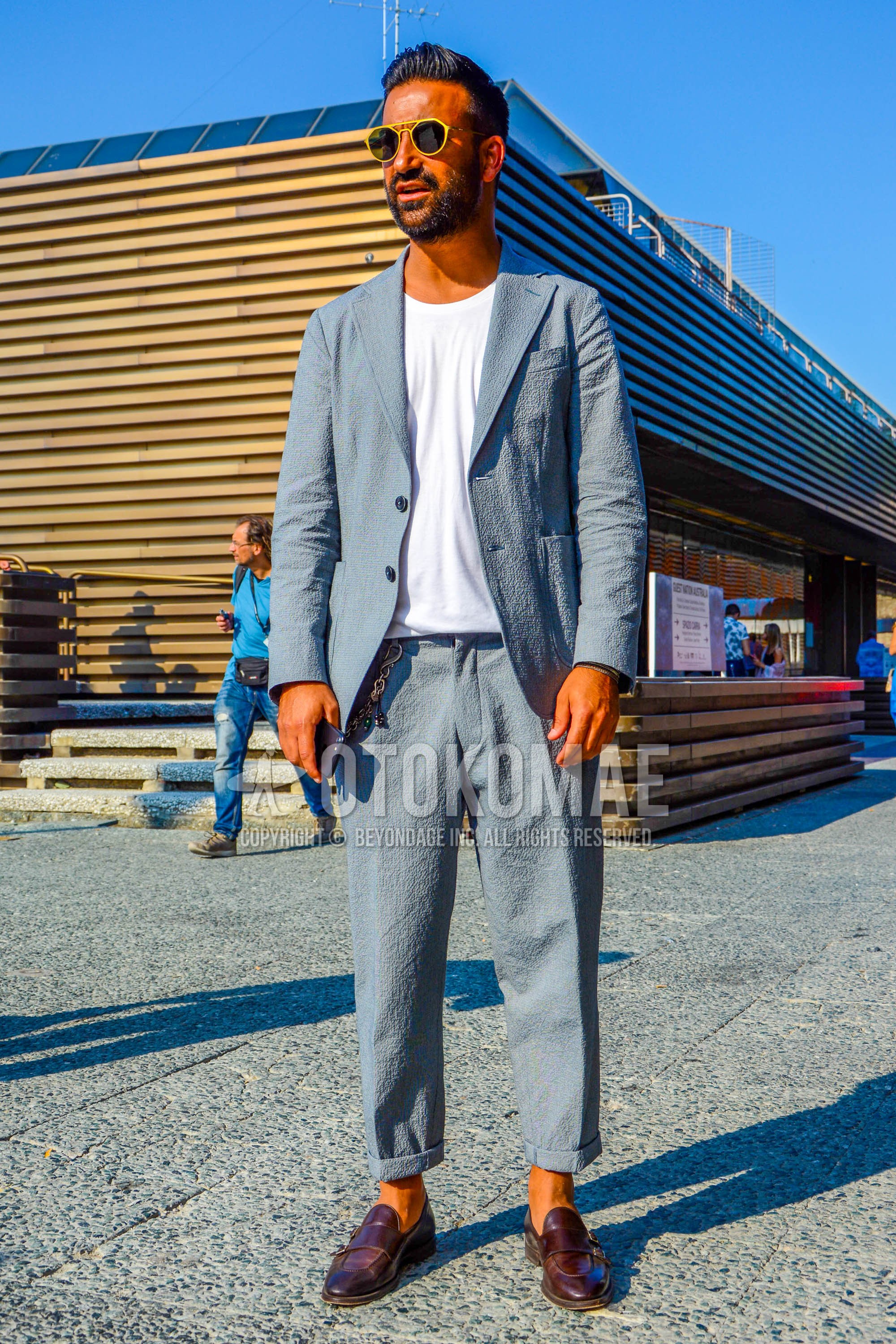 Men's spring summer outfit with plain sunglasses, white plain t-shirt, brown  loafers leather shoes, gray plain suit.