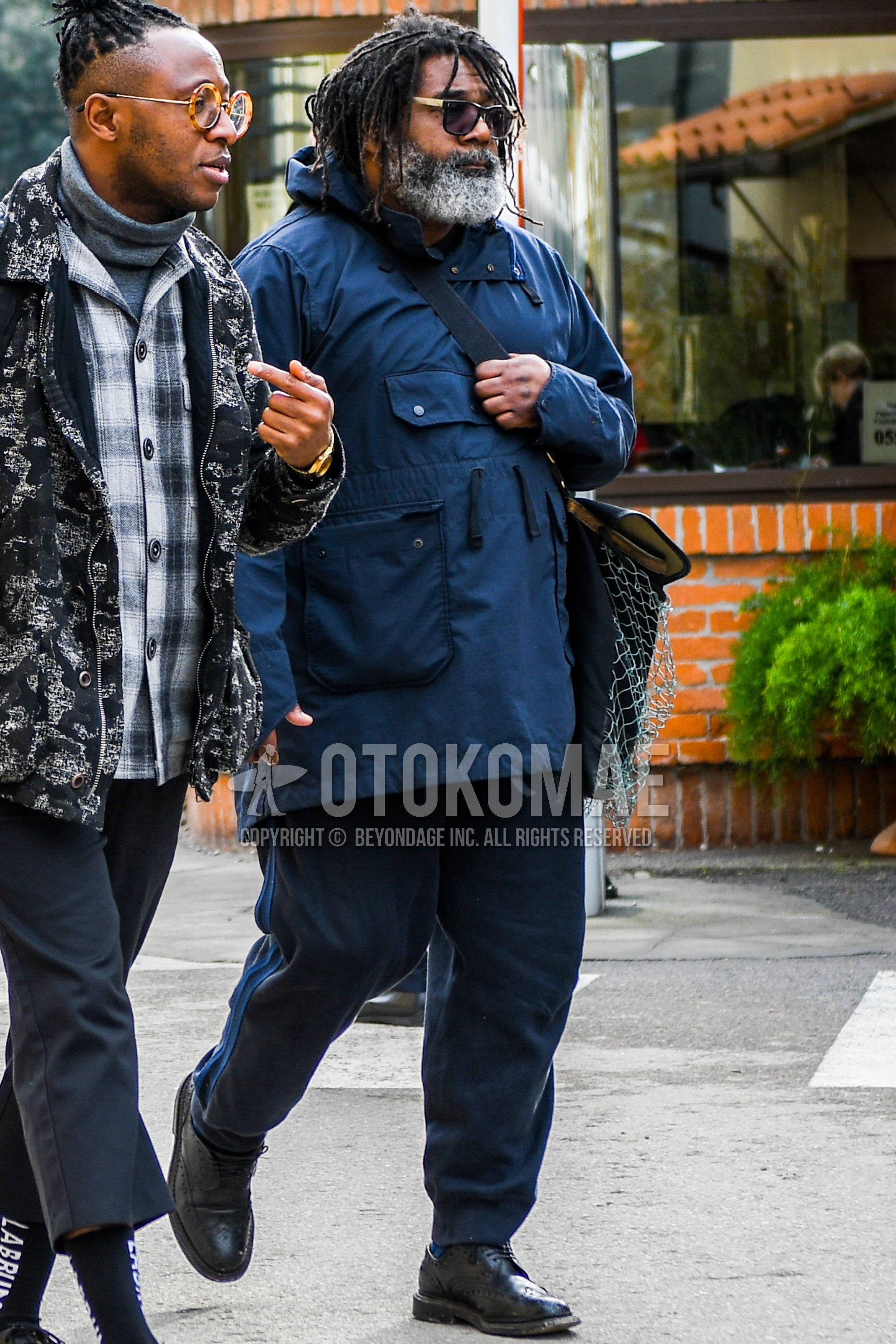 Men's winter outfit with plain sunglasses, blue plain hooded coat, navy plain cotton pants, black brogue shoes leather shoes.