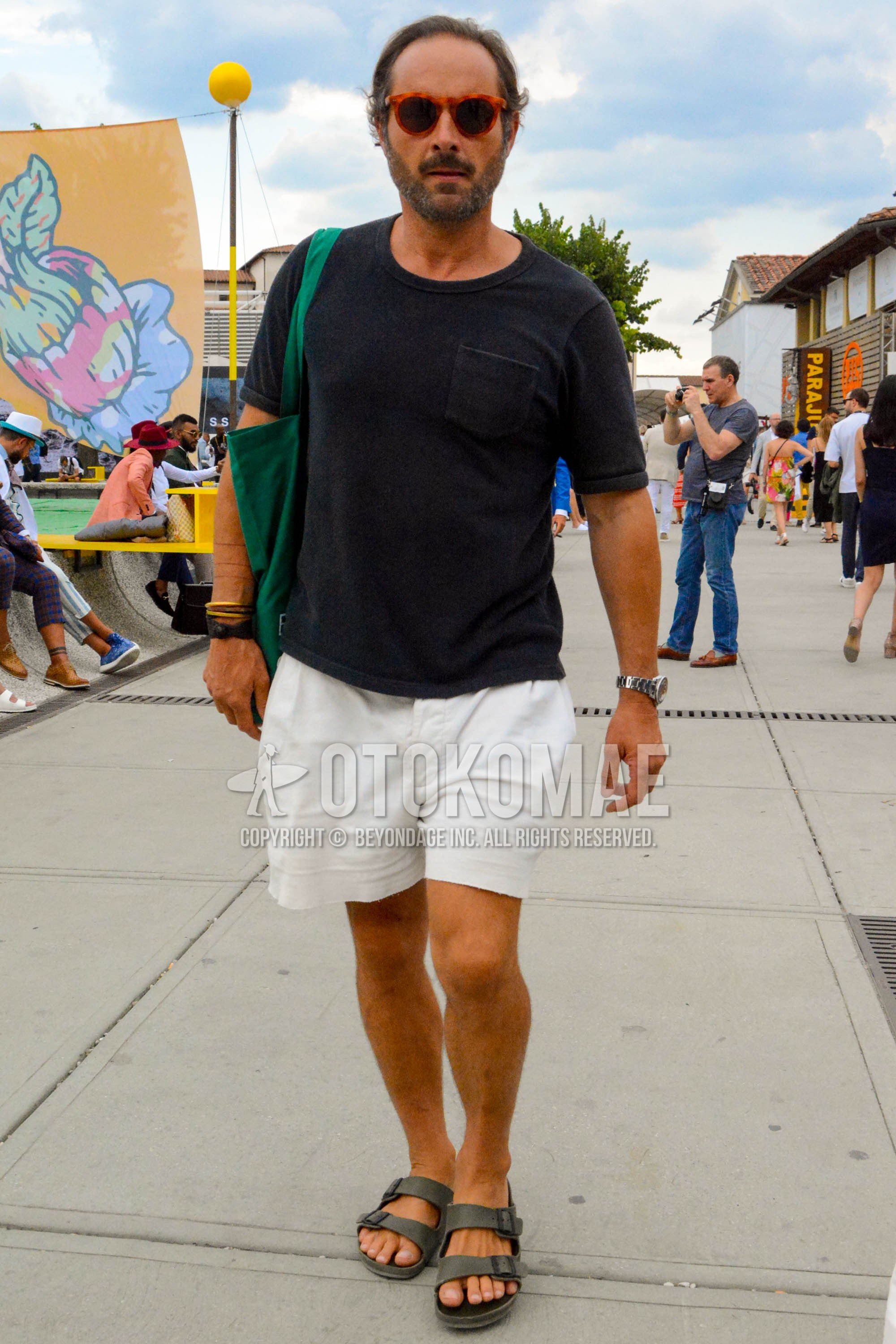 Men's summer outfit with plain sunglasses, black plain t-shirt, white plain short pants, gray shower sandals.
