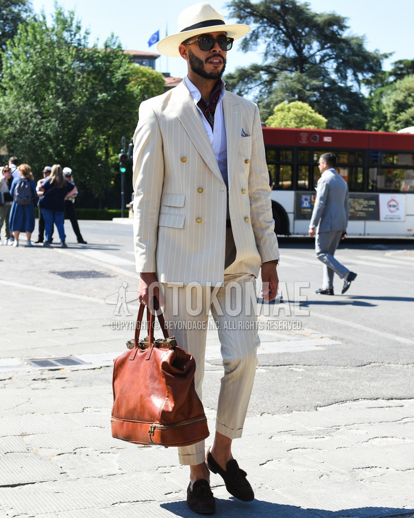 Men's spring summer outfit with white plain hat, brown plain sunglasses, red tortoiseshell scarf, white plain shirt, brown tassel loafers leather shoes, brown plain boston bag, beige stripes suit.