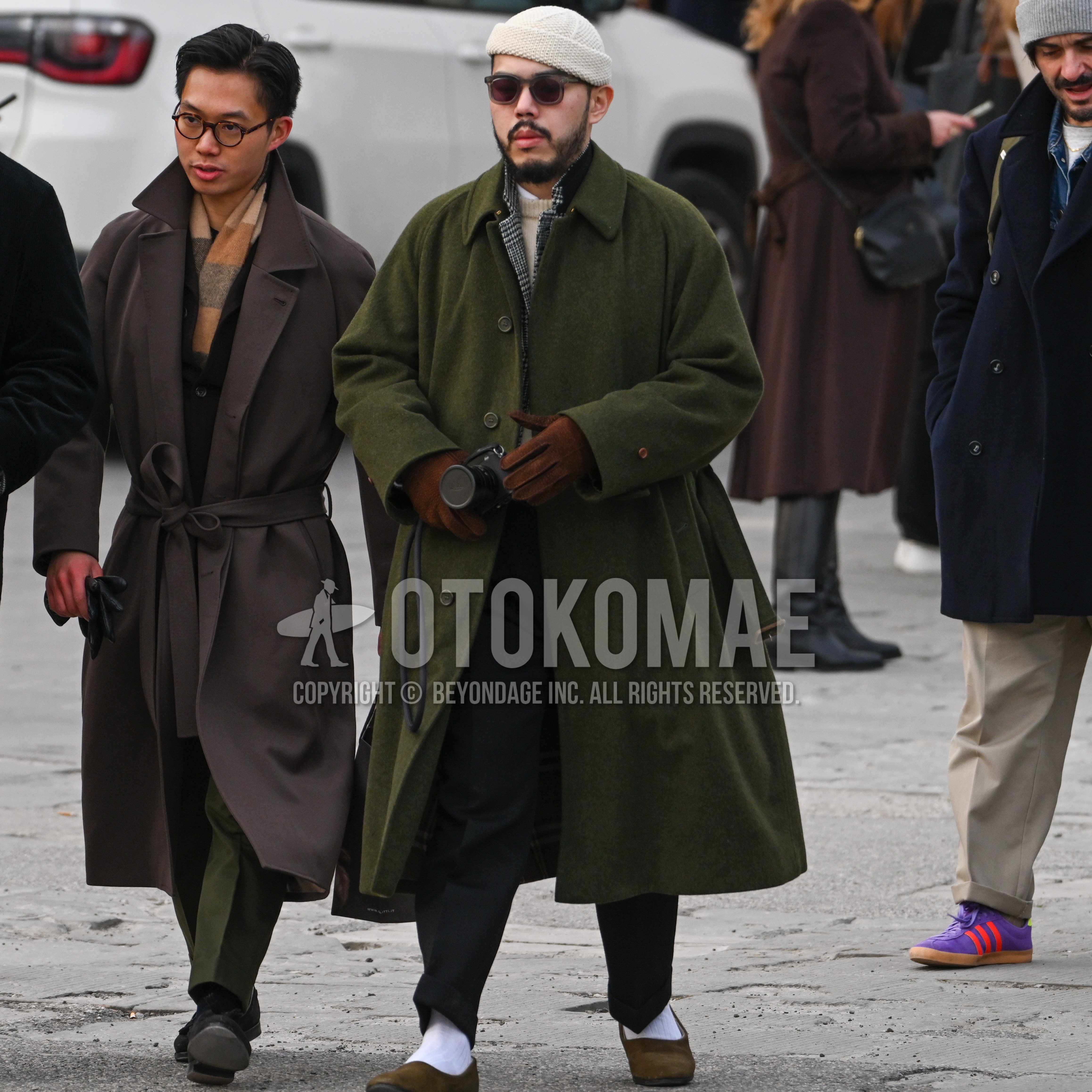Men's autumn winter outfit with white plain knit cap, dark gray plain sunglasses, olive green plain stenkarrer coat, gray check tailored jacket, white plain shirt, beige plain sweater, black plain slacks, white plain socks, brown suede shoes leather shoes.