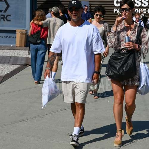 黒レタードのベースボールキャップ、レイバンの黒無地のサングラス、白無地のTシャツ、白無地のショートパンツ、白無地のソックス、ヴァンズ　オールドスクールの黒ローカットのスニーカー、ナップザックの白無地のバッグを合わせた夏春のメンズコーデ・着こなし。