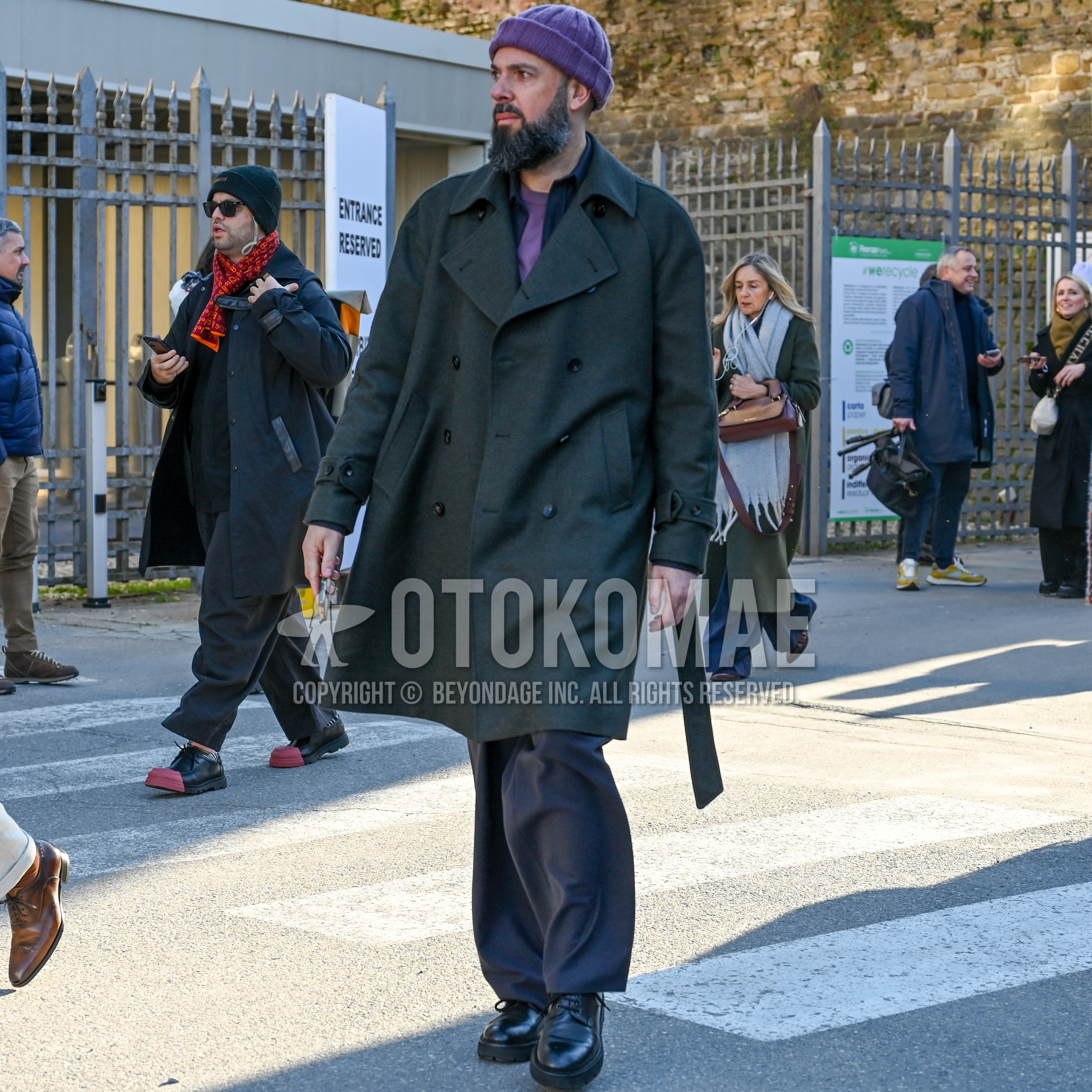 Men's autumn winter outfit with purple plain knit cap, dark gray plain chester coat, dark gray plain shirt, purple plain long sleeve t-shirt, dark gray plain slacks, black plain toe leather shoes.