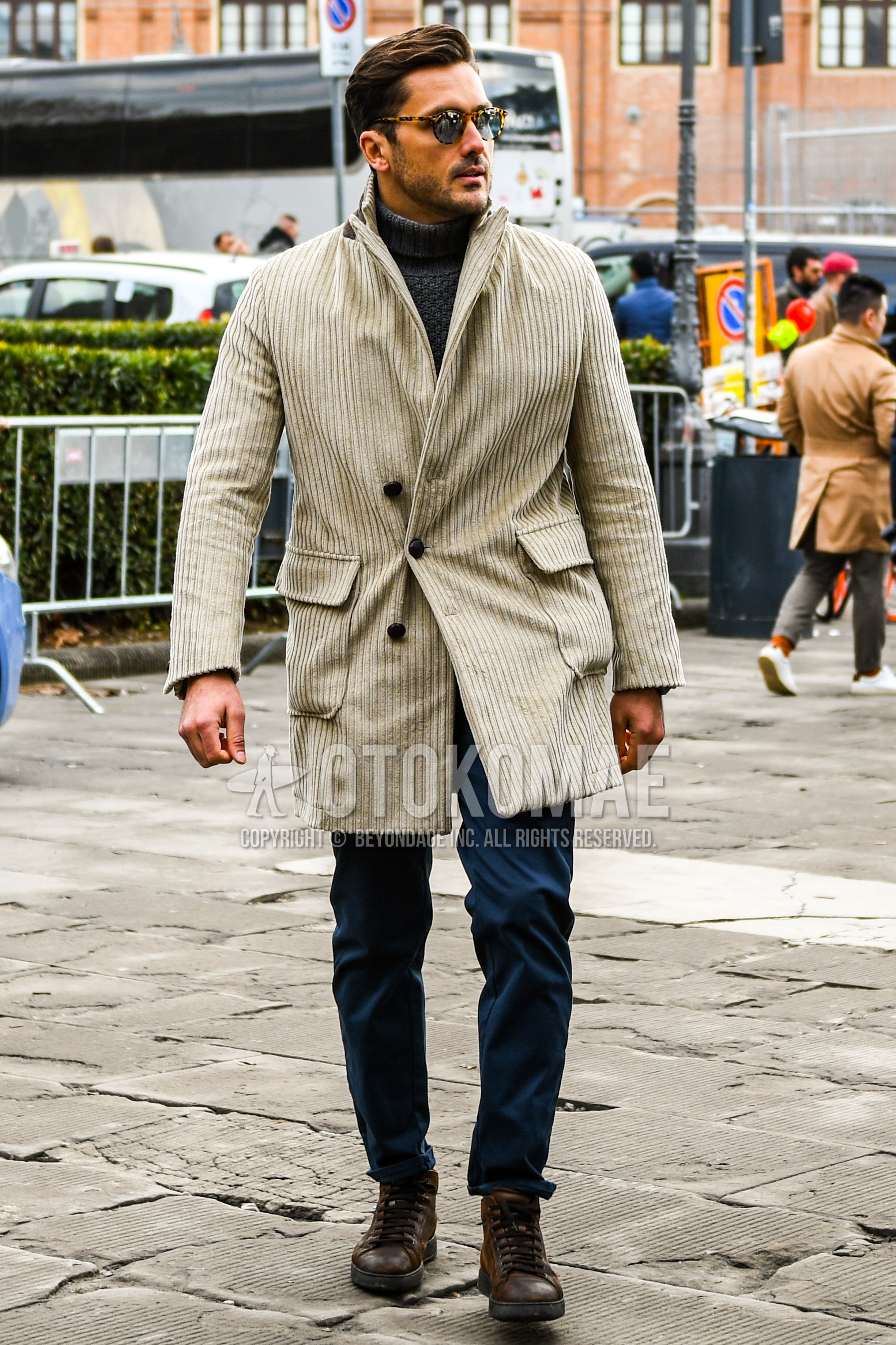 Men's autumn winter outfit with plain sunglasses, beige plain chester coat, gray plain turtleneck knit, gray plain cotton pants, brown high-cut sneakers.