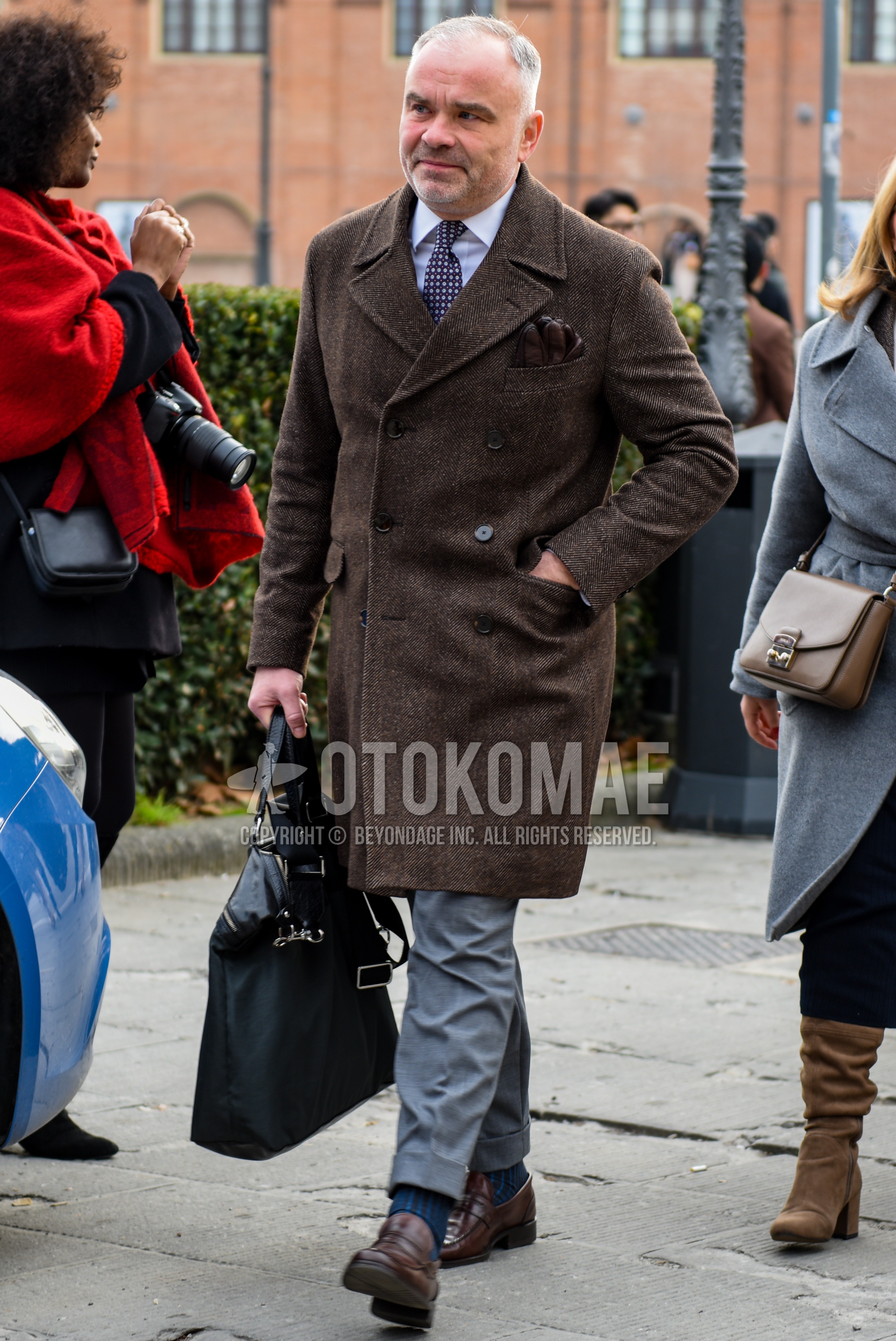 Men's autumn winter outfit with brown herringbone chester coat, white plain shirt, gray plain slacks, navy socks socks, multi-color dots necktie.