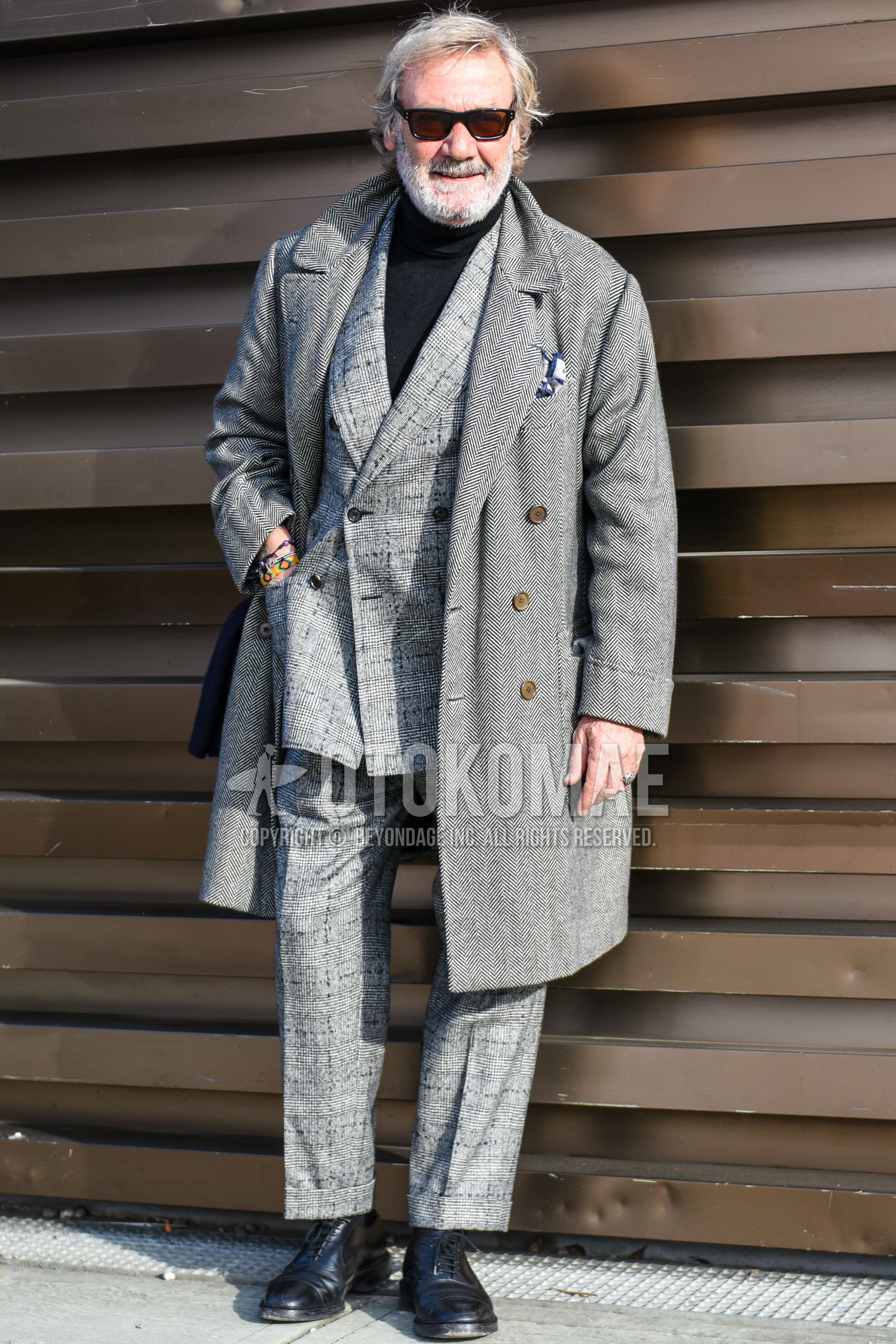 Men's autumn winter outfit with black plain sunglasses, gray herringbone chester coat, black plain turtleneck knit, black straight-tip shoes leather shoes, gray check suit.