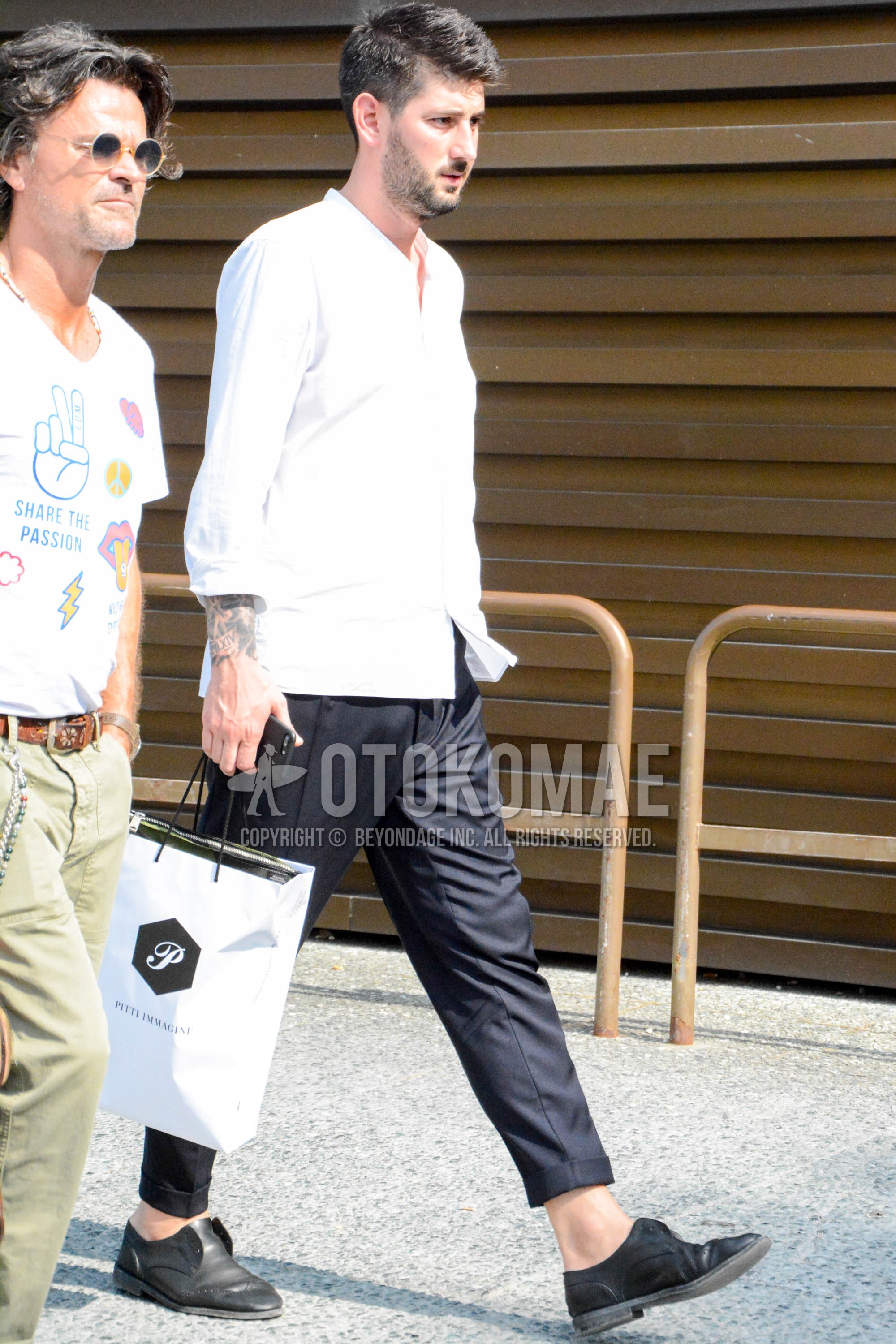 Men's spring summer outfit with white plain shirt, black plain slacks, black plain cropped pants, black  leather shoes.
