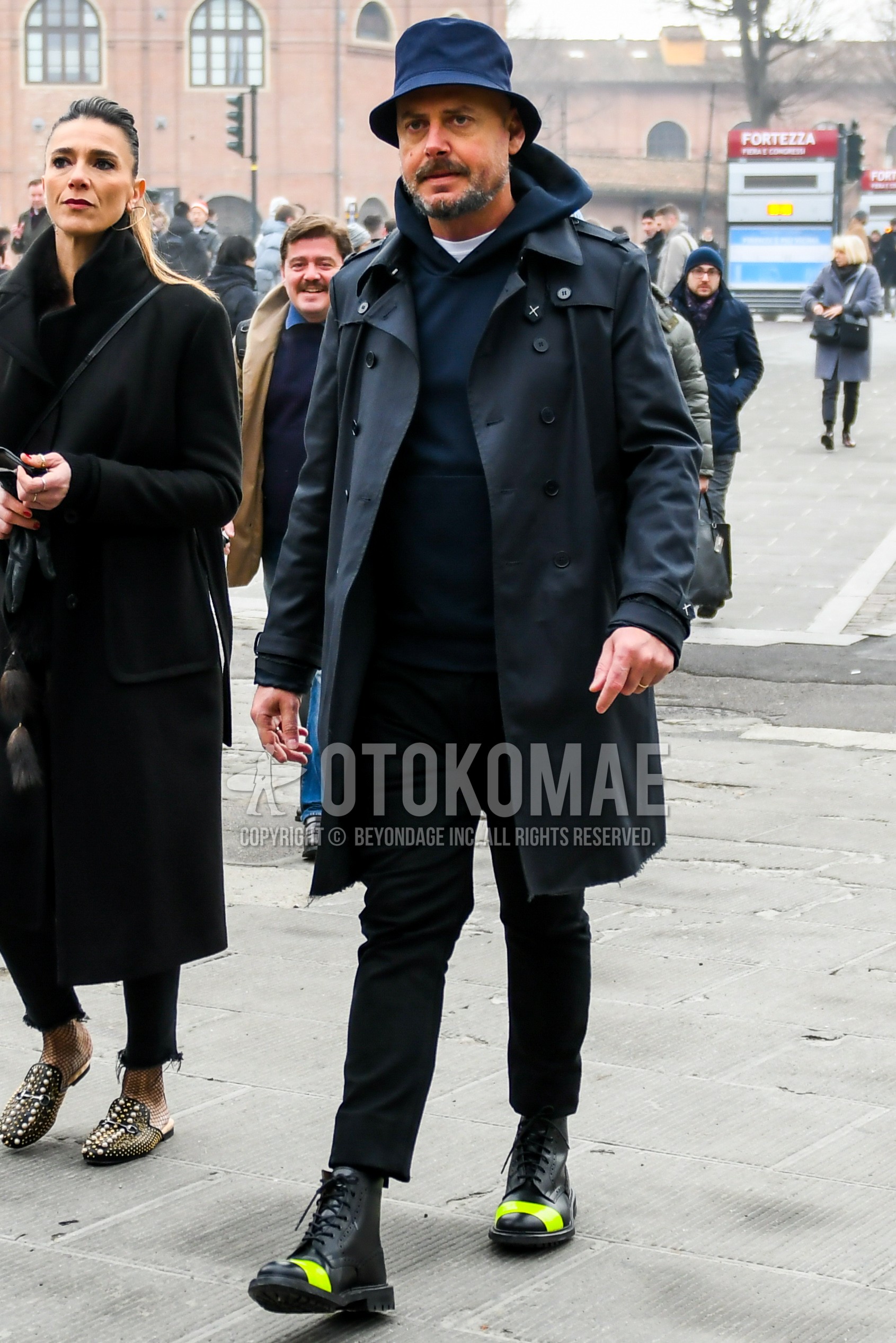 Men's winter outfit with navy plain hat, black plain trench coat, navy plain hoodie, black plain ankle pants, black  boots.