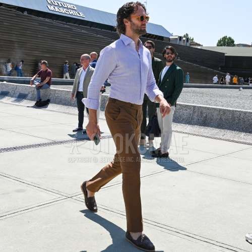 オレンジ無地のサングラス、パープル無地のシャツ、ブラウン無地のスラックス、ブラウン無地のベルトレスパンツ、ブラウン無地のアンクルパンツ、ブラウンローファーの革靴を合わせた夏春のメンズコーデ・着こなし。