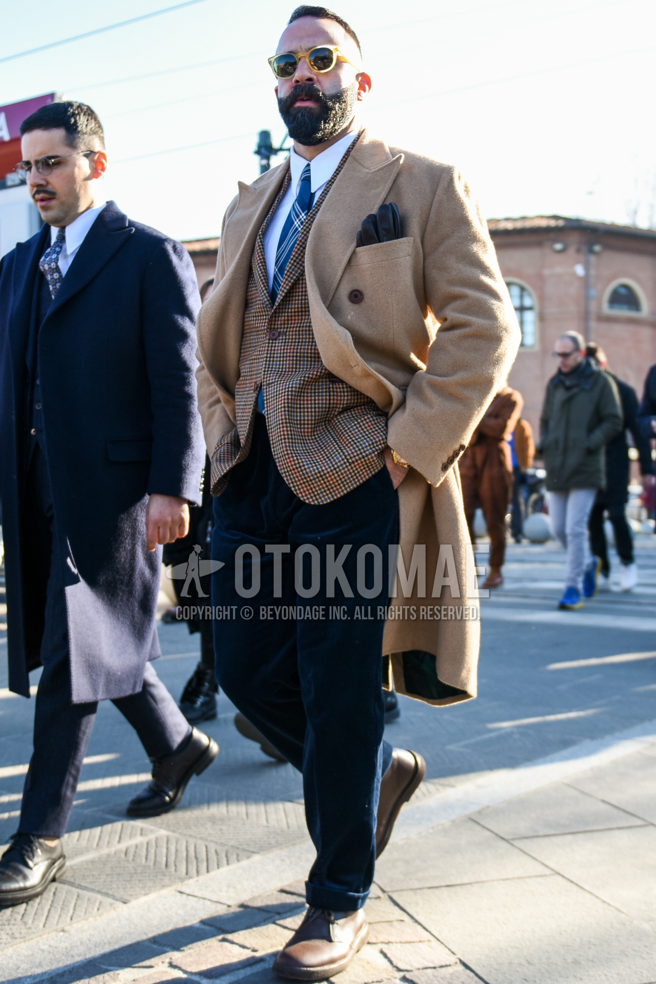 Men's autumn winter outfit with clear beige plain sunglasses, beige plain chester coat, brown check tailored jacket, white plain shirt, navy plain winter pants (corduroy,velour), brown  boots, gray necktie necktie.