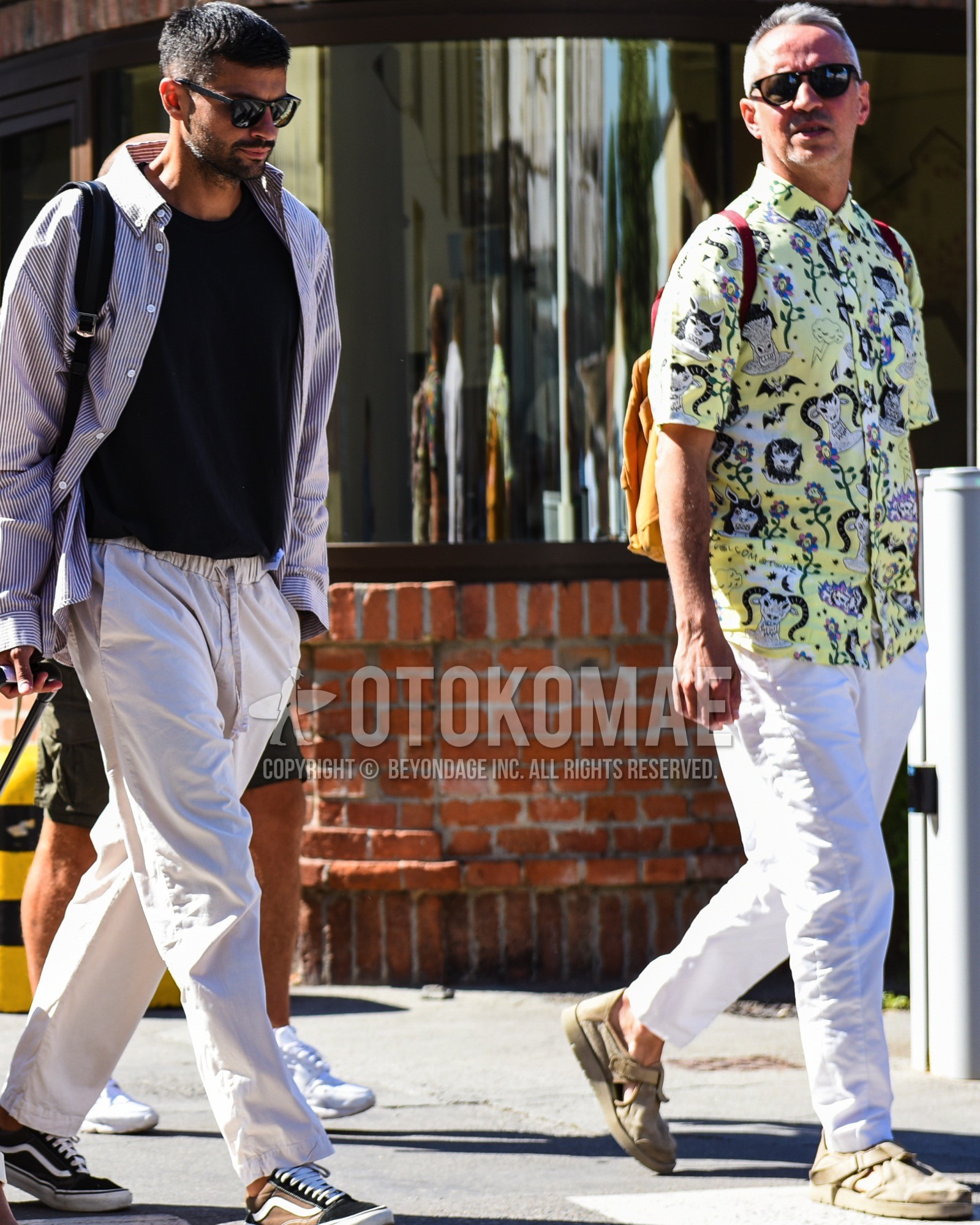 Men's spring summer outfit with black plain sunglasses, yellow tops/innerwear shirt, white plain cotton pants, beige low-cut sneakers, brown plain backpack.