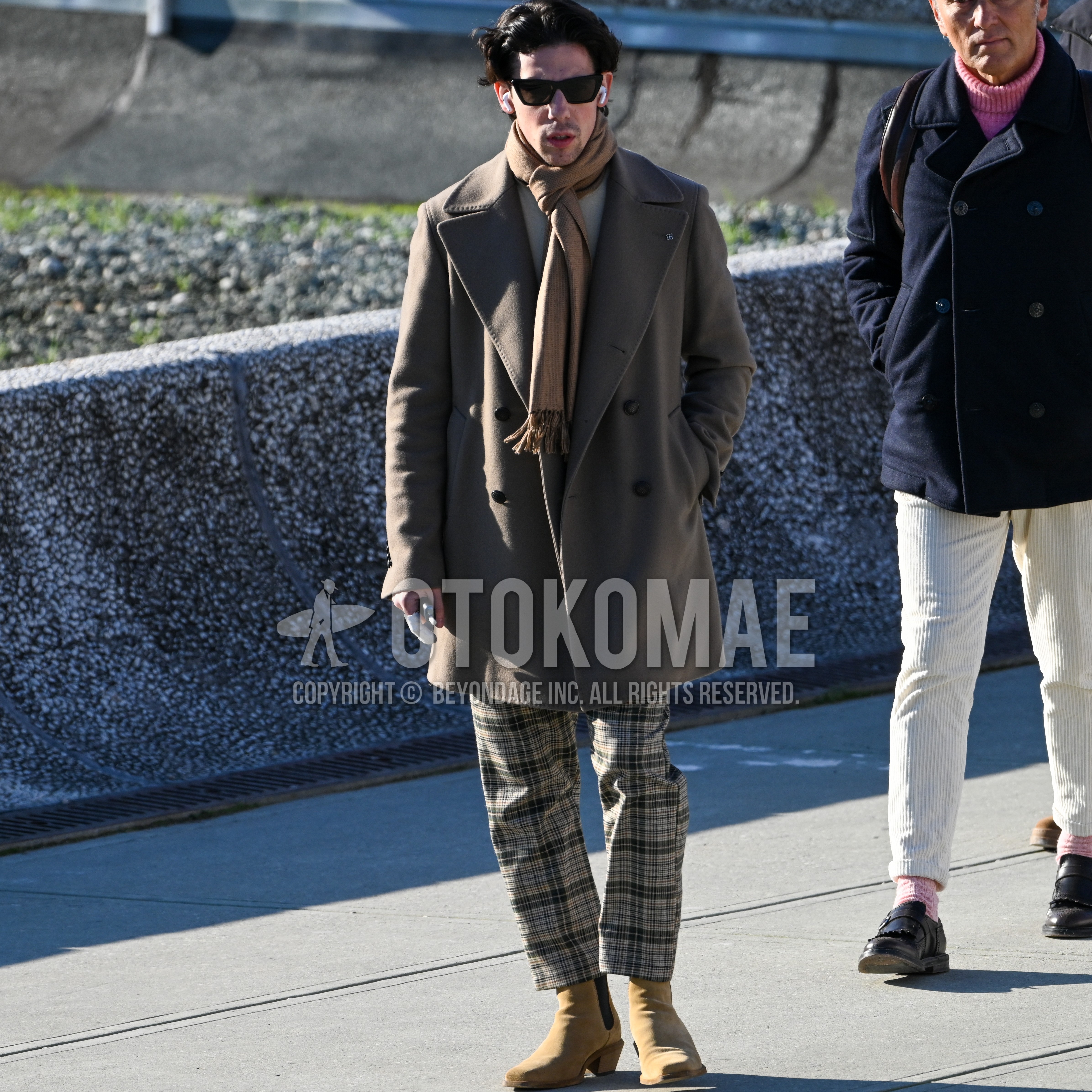 Men's autumn winter outfit with black plain sunglasses, beige plain scarf, gray plain chester coat, beige plain sweater, beige brown check bottoms, brown beige  boots.