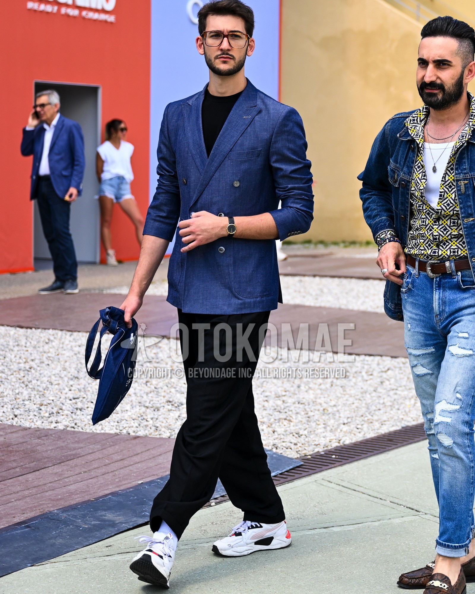 Men's spring summer autumn outfit with clear plain sunglasses, navy plain tailored jacket, black plain t-shirt, black plain slacks, white plain socks, white low-cut sneakers.
