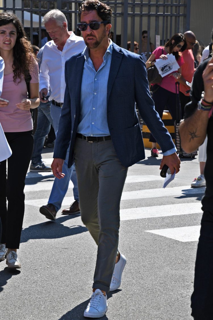 Navy jacket and gray pants jackets with sneakers for a casual down-do
