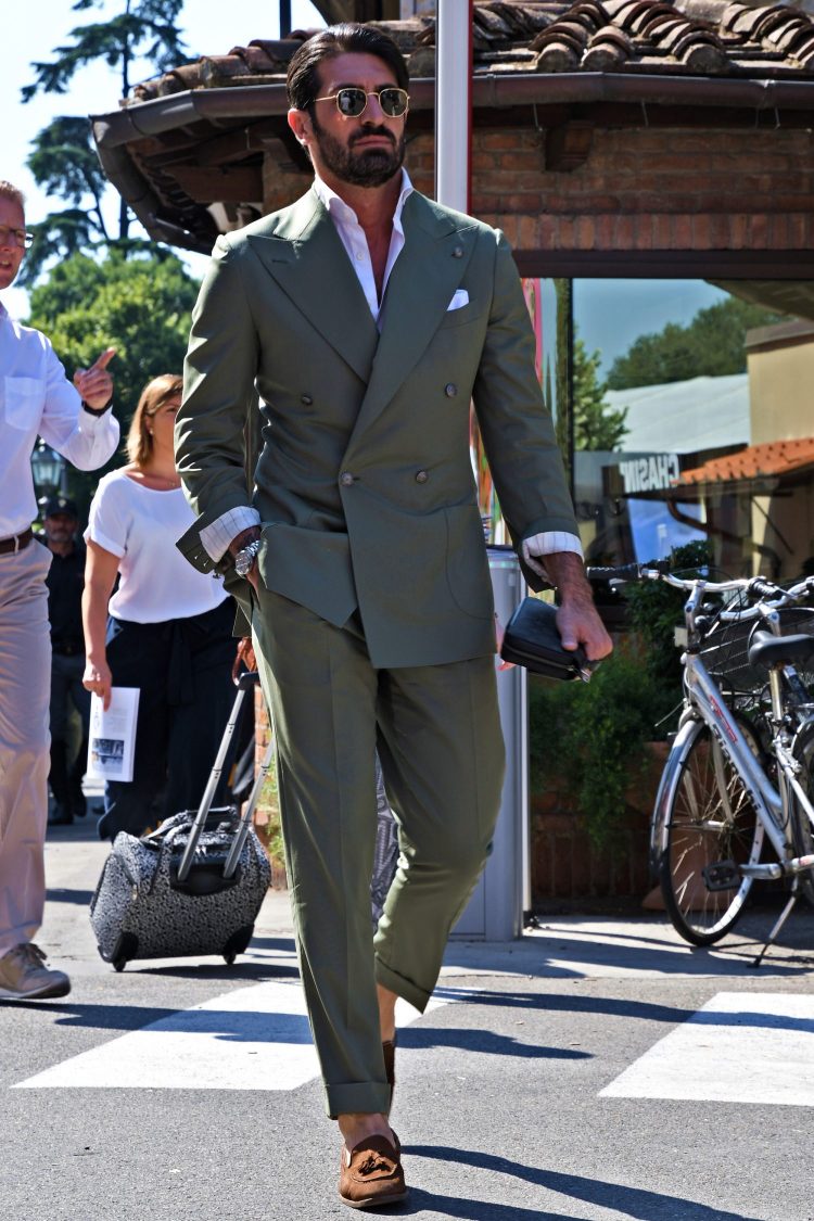 Vintage-inspired hexagon-framed sunglasses that blend in with a classic suit outfit.