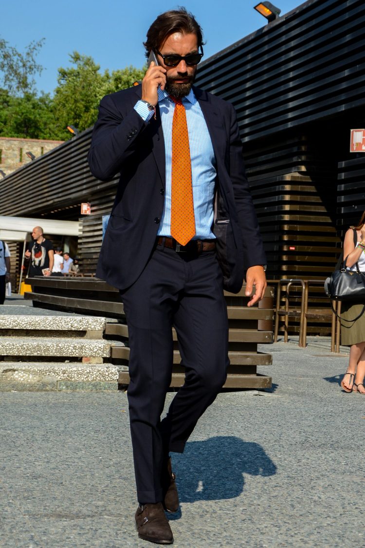 Brown suede shoes on the feet of the navy suit add a soft touch