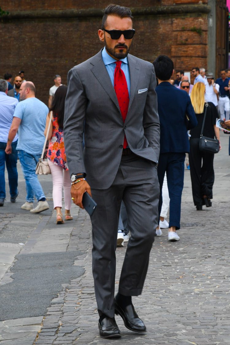 Gray suit with red tie to brighten the V-zone