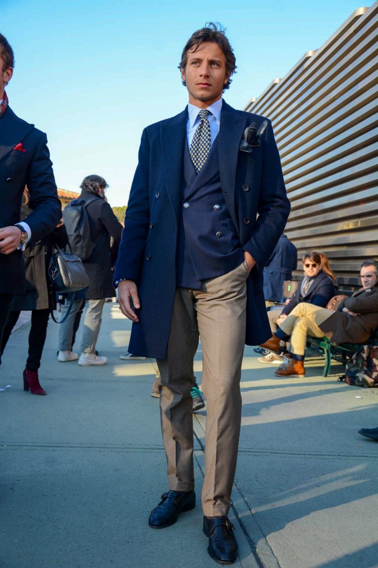 Leather gloves are placed in the breast pocket of the chester coat for a cozy look