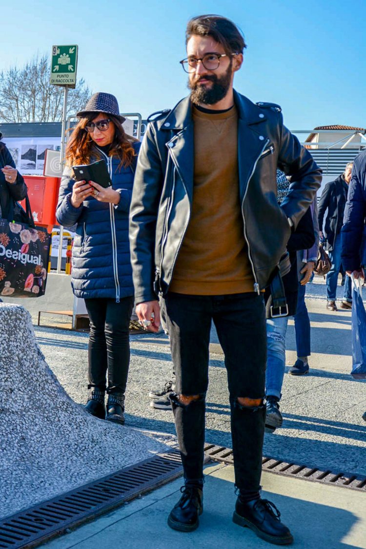 Ripped black denim and a rider's jacket for a rugged look