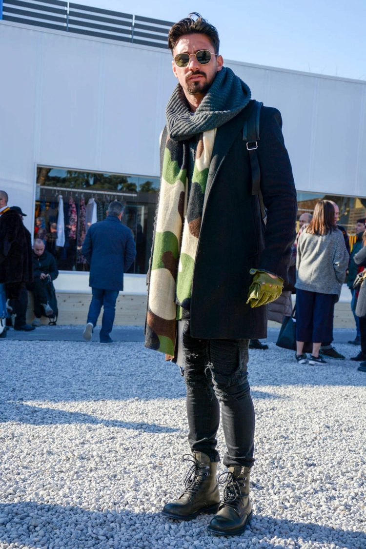 Damaged black denim and work boots for a rugged look