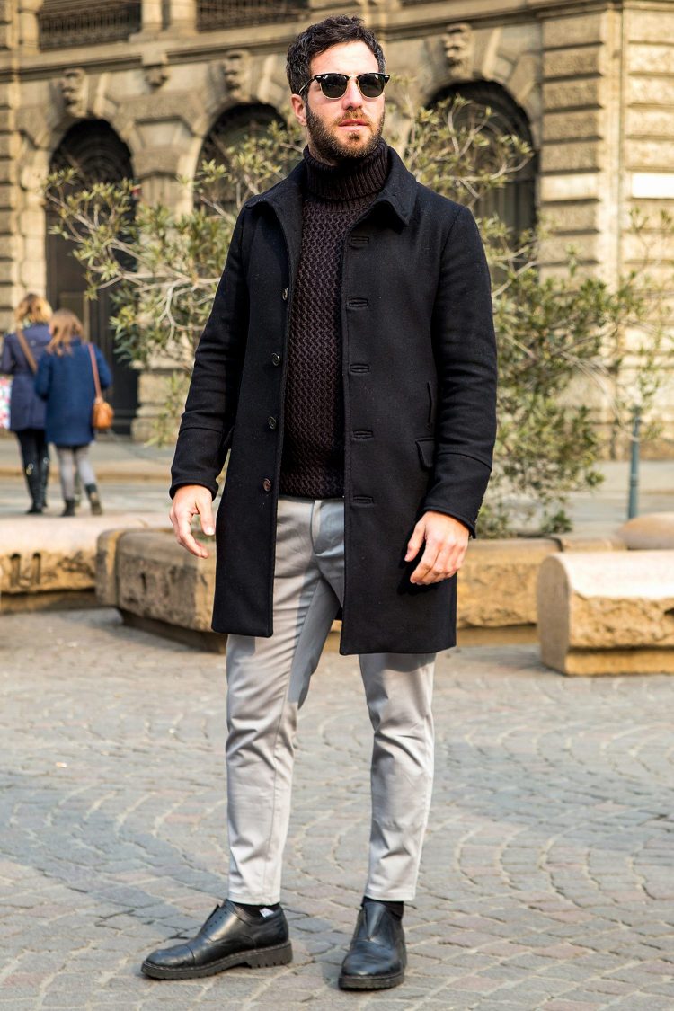 Brown turtleneck knit and black coat express modern color matching