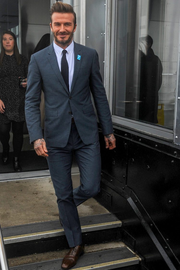 Mr. Beckham wearing a suit and knit tie