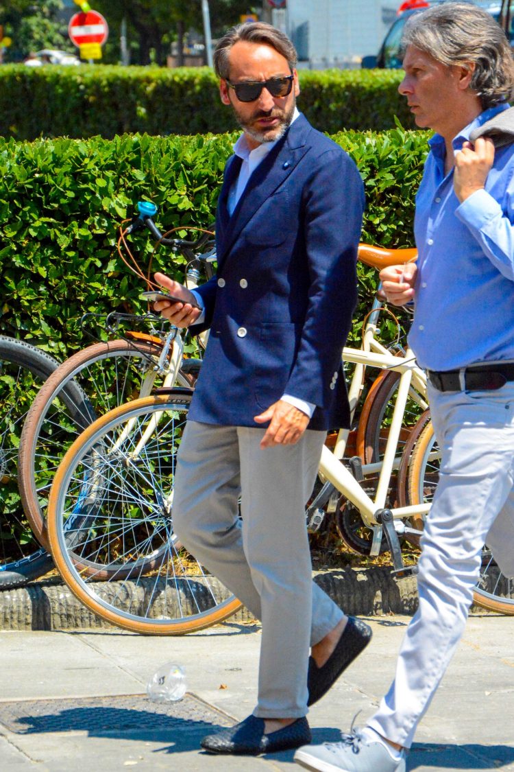 Navy double jacket and gray pants for a royal look.