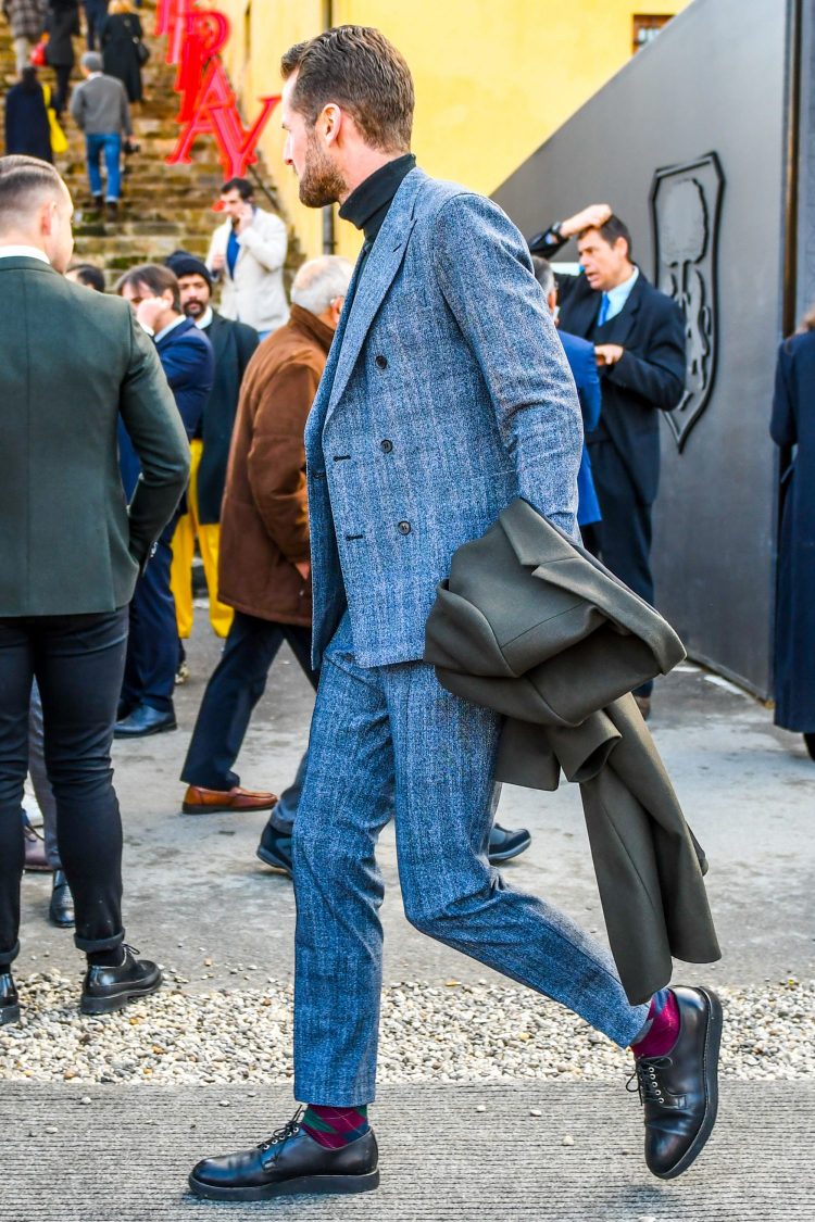 Spice up the chic grey suit style with a black turtleneck knit and glamorous argyle check socks.