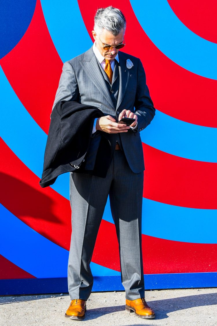 Daring to wear wingtips with a gray three-piece suit