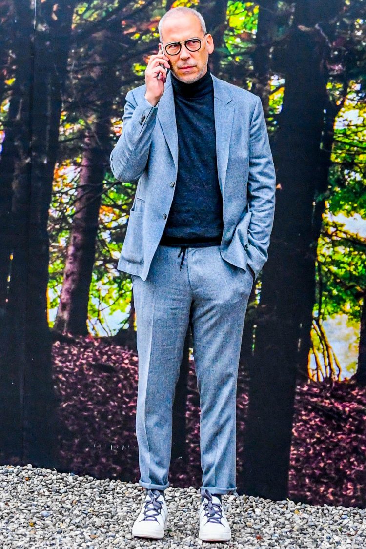 Functional gray suit with turtleneck knit and sneakers for a casual-down look
