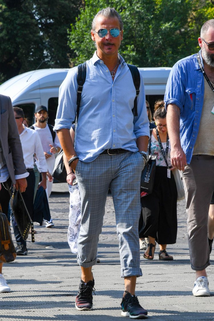 Gray pants coordinate with top and bottoms both rolled up for a light look