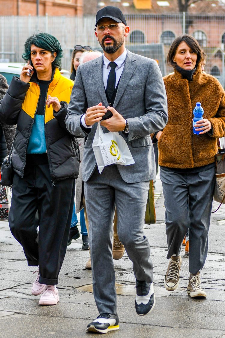 Gray suit and sneakers with a leather shoe-like design for a casual look