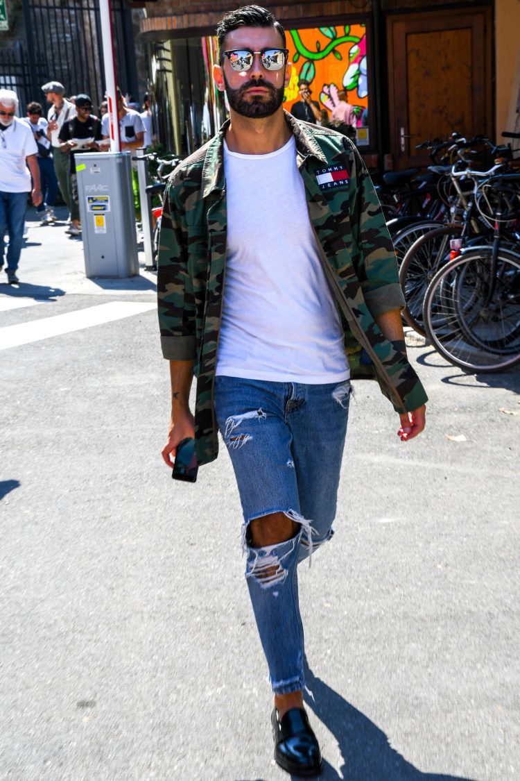 Damaged jeans styled with military jacket