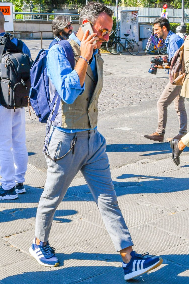 Spice up your blue shirt look with a khaki gilet