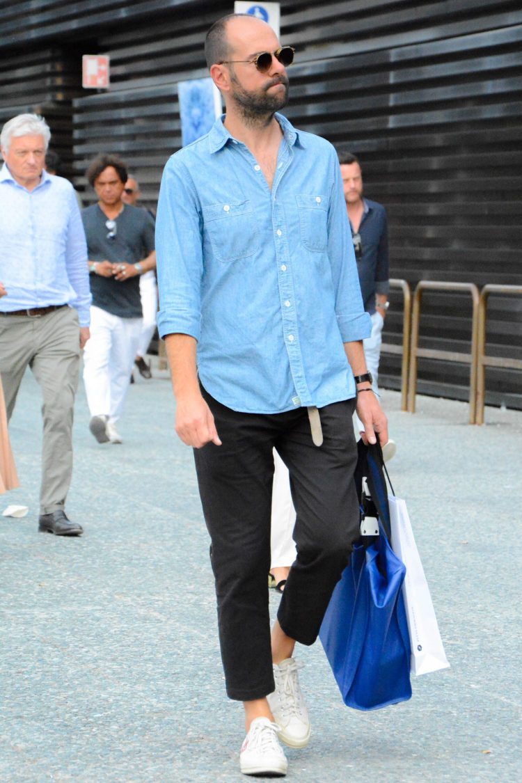 Light-colored denim shirt pulled together with black pants