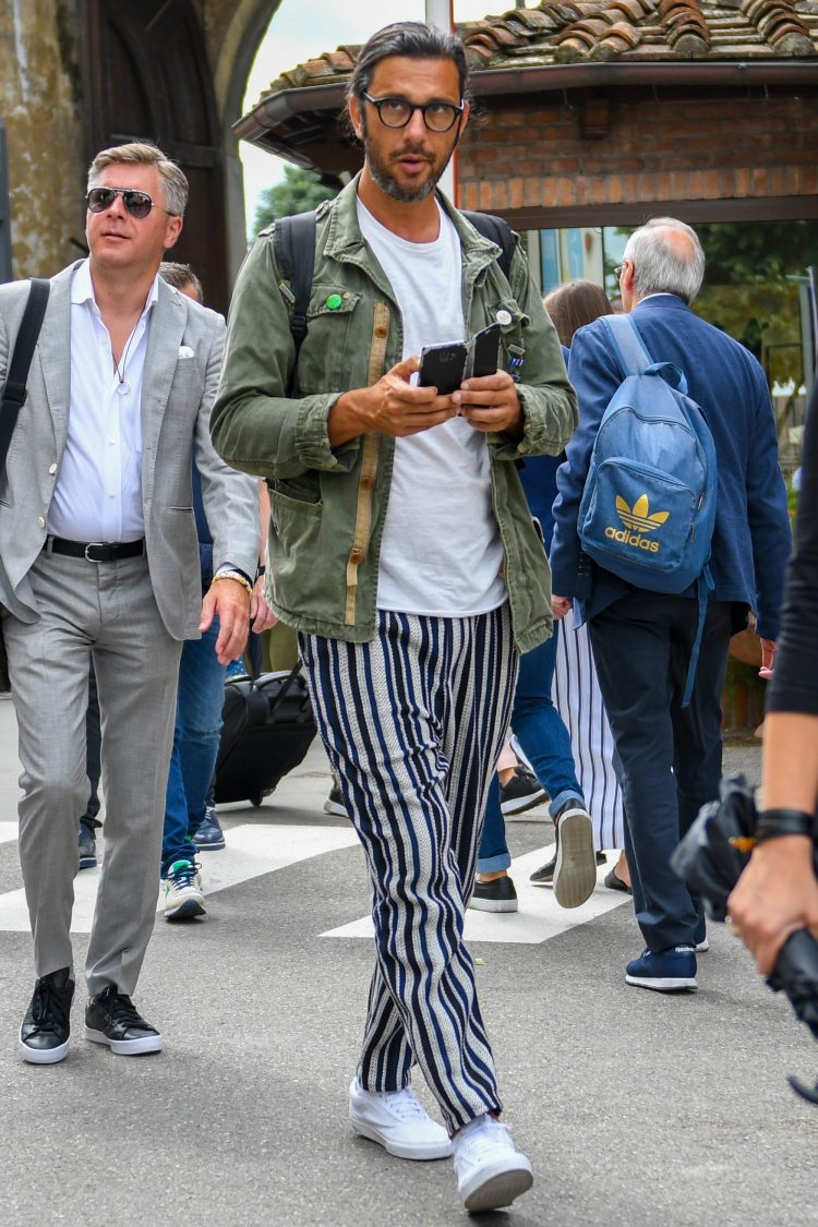 Khaki shirt coordinate with striped pants and Boston frame eyewear for an intelligent look