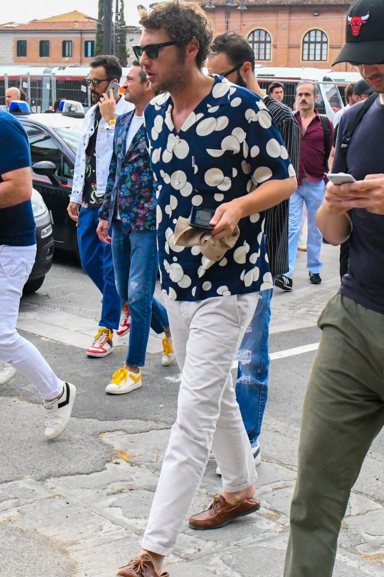 Polka-dot open-collared shirt and white pants for a fresh look